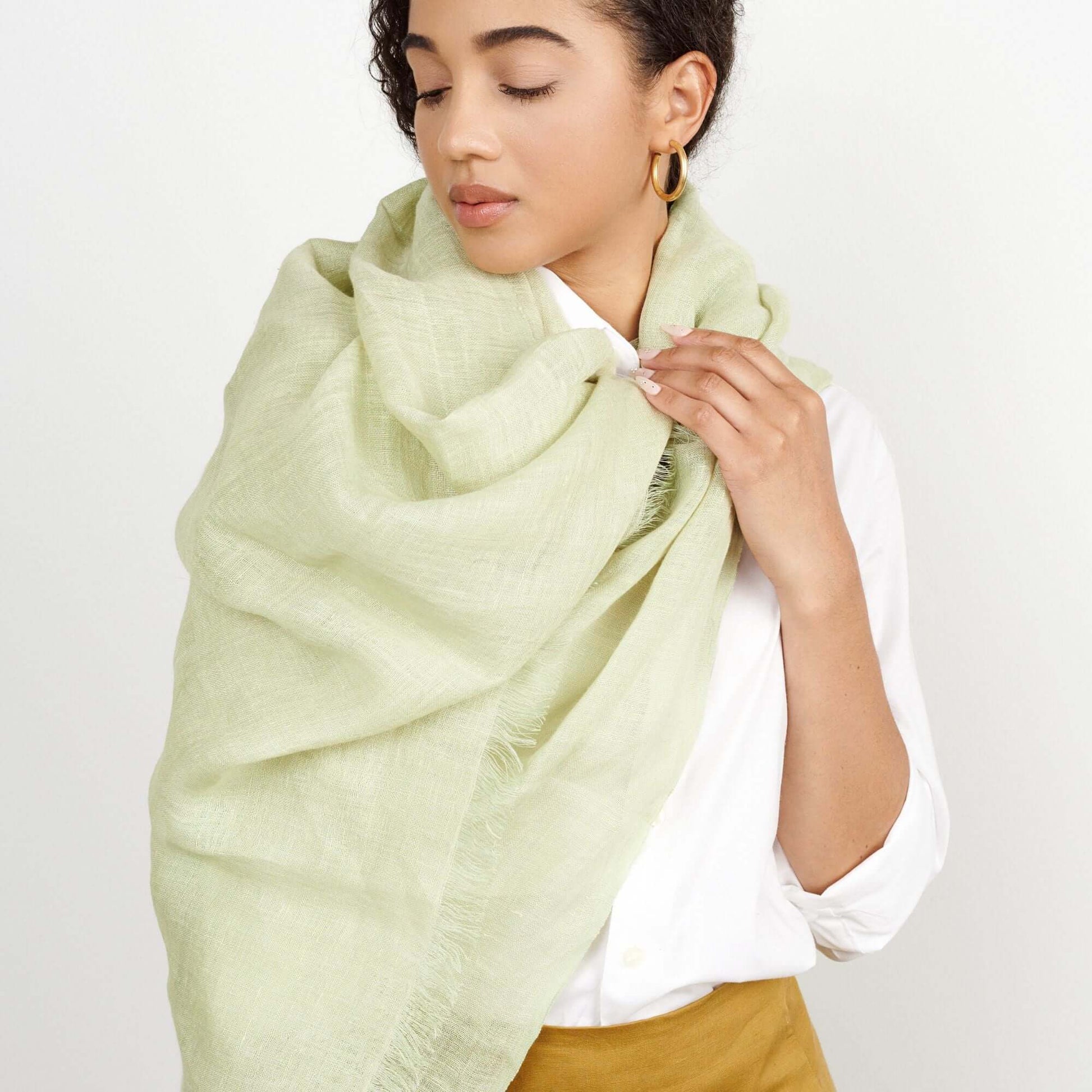 Soya Pastel Lime Green Hand Woven Soft Linen Scarf elegantly draped on a model's shoulder.