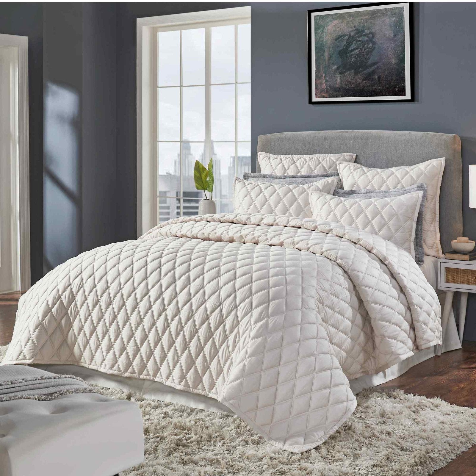 CL-180-11096_2|Cream quilted coverlet draped on modern bed, showcasing subtle pattern, enhancing contemporary bedroom decor.
