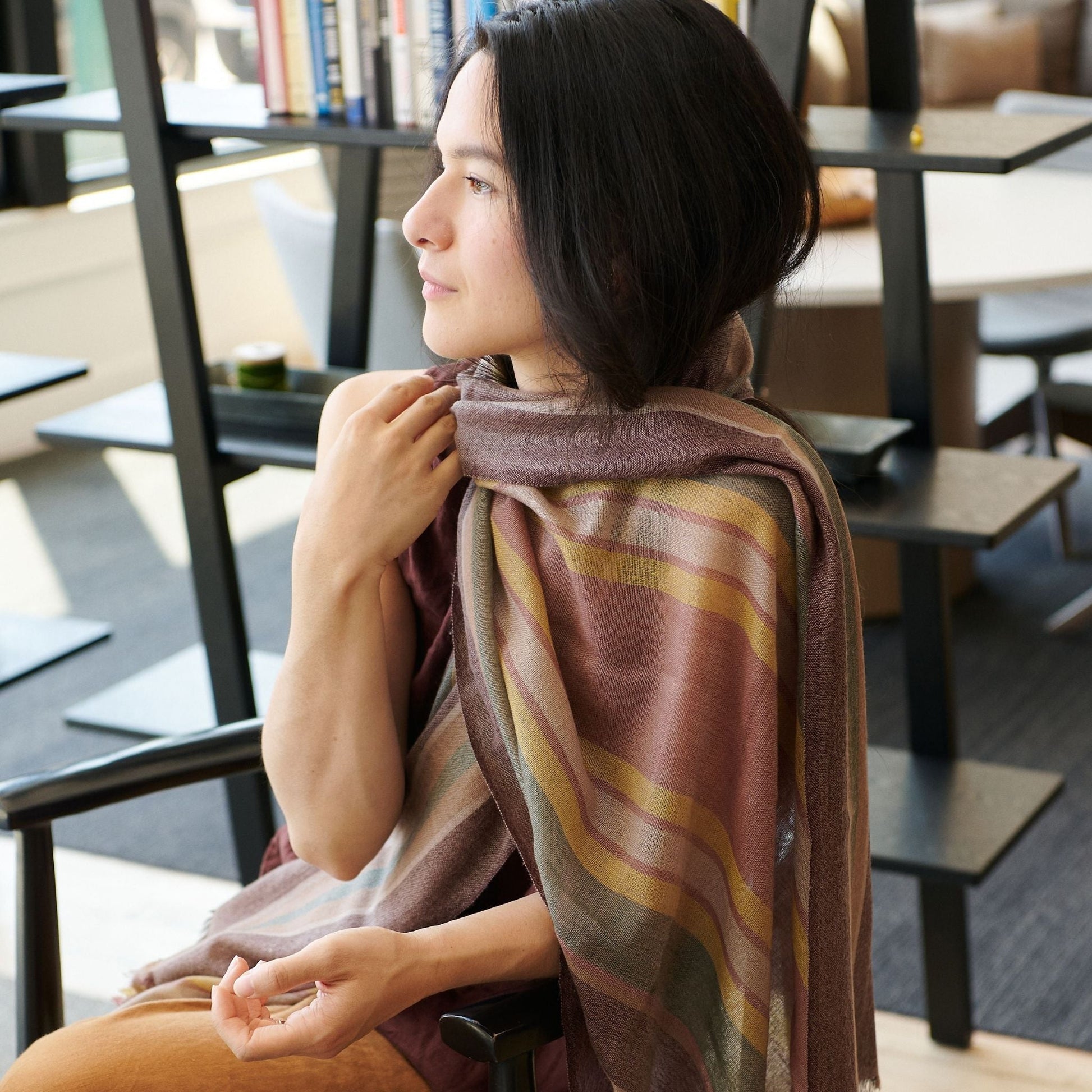 Woman wearing the Barque Clay Modern Artisan Striped Soft Merino Handwoven Scarf in a stylish setting.