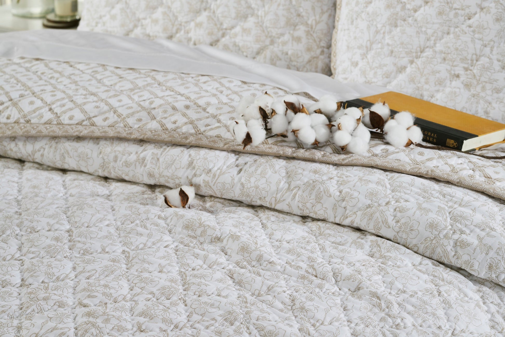 QT-346-11096_4|Detailed view of natural beige floral quilted bedding. Includes patterned quilt and cotton bolls decoration. Soft bedroom linens.