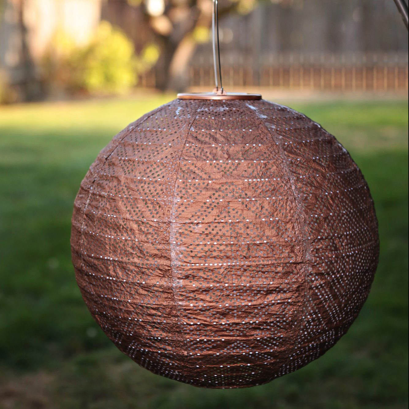 Soji Stella Market 12" Tyvek Solar Lantern in backyard