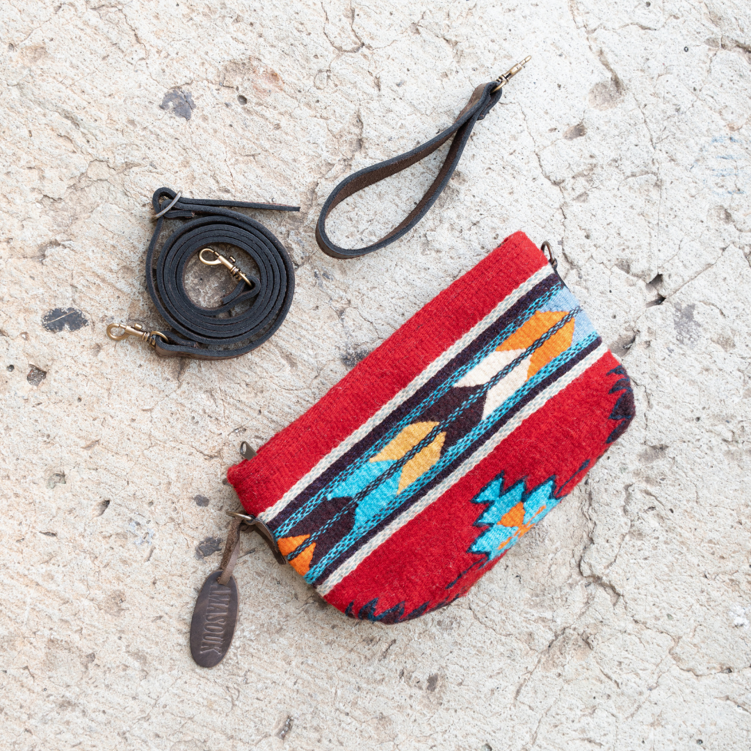 Handwoven convertible clutch with Zapotec pattern in bold colors; can be used as a pouch, wristlet, or crossbody with included leather straps and internal pocket.