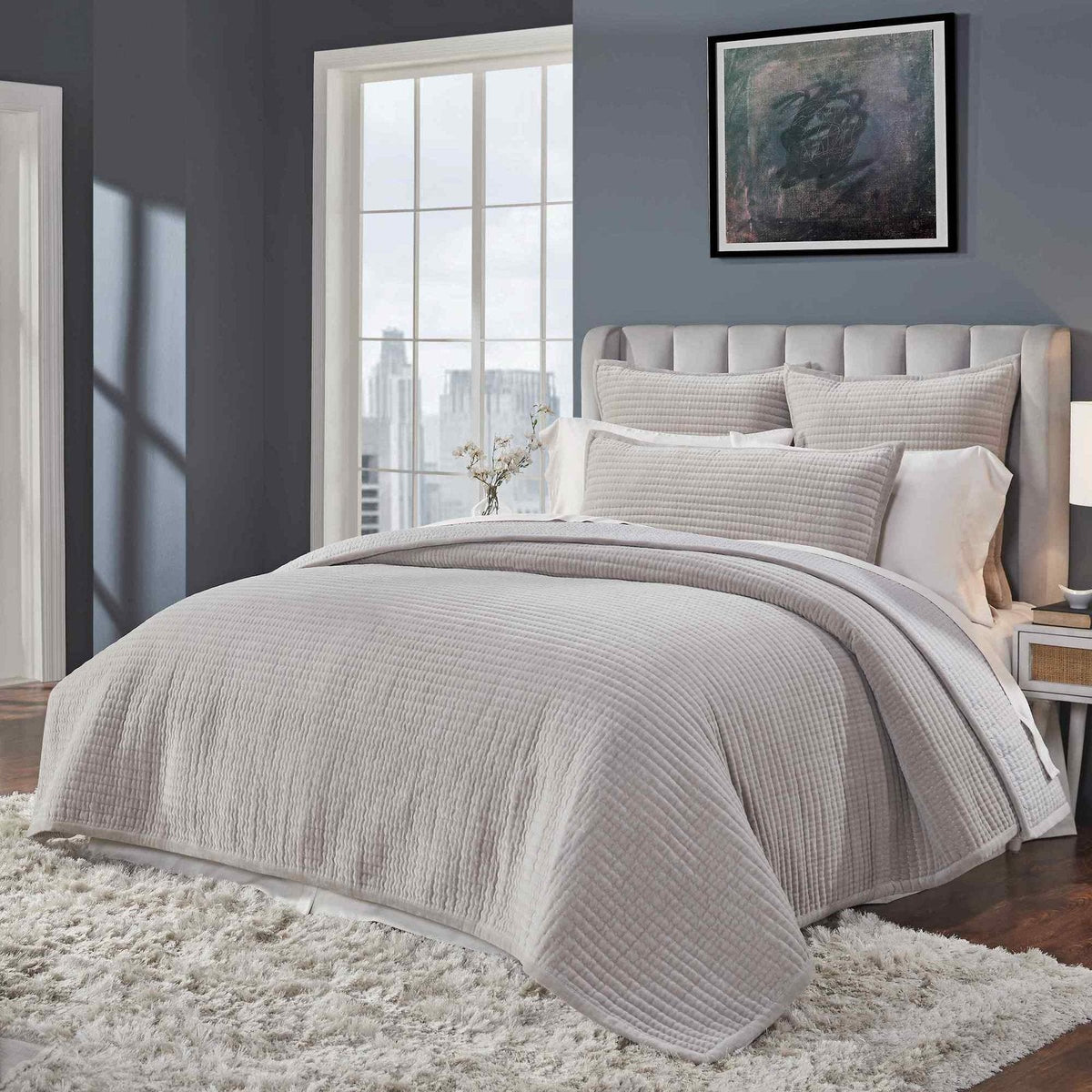 CL-188-11096_4|Side view of a modern bed featuring a plush grey quilted coverlet with a defined channel stitch pattern.