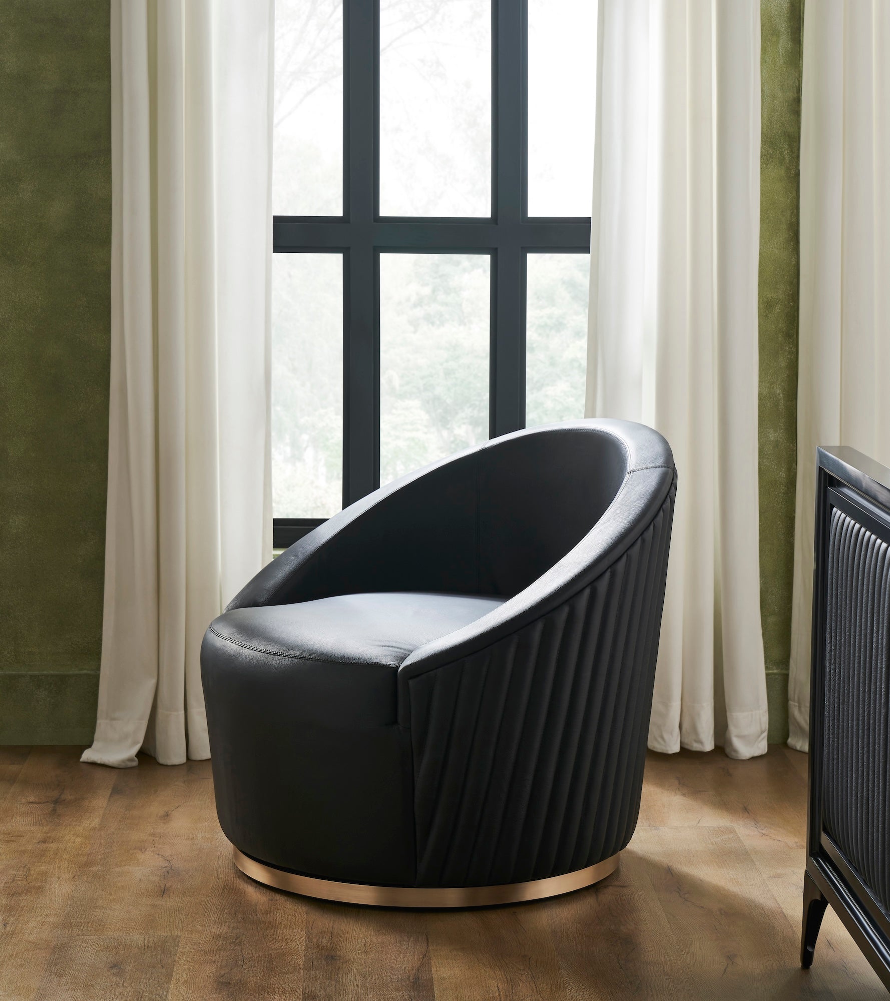 FN-5207-353529_1|Modern black leather swivel armchair featuring elegant vertical ribbed detailing on back and stylish polished gold metal round base.