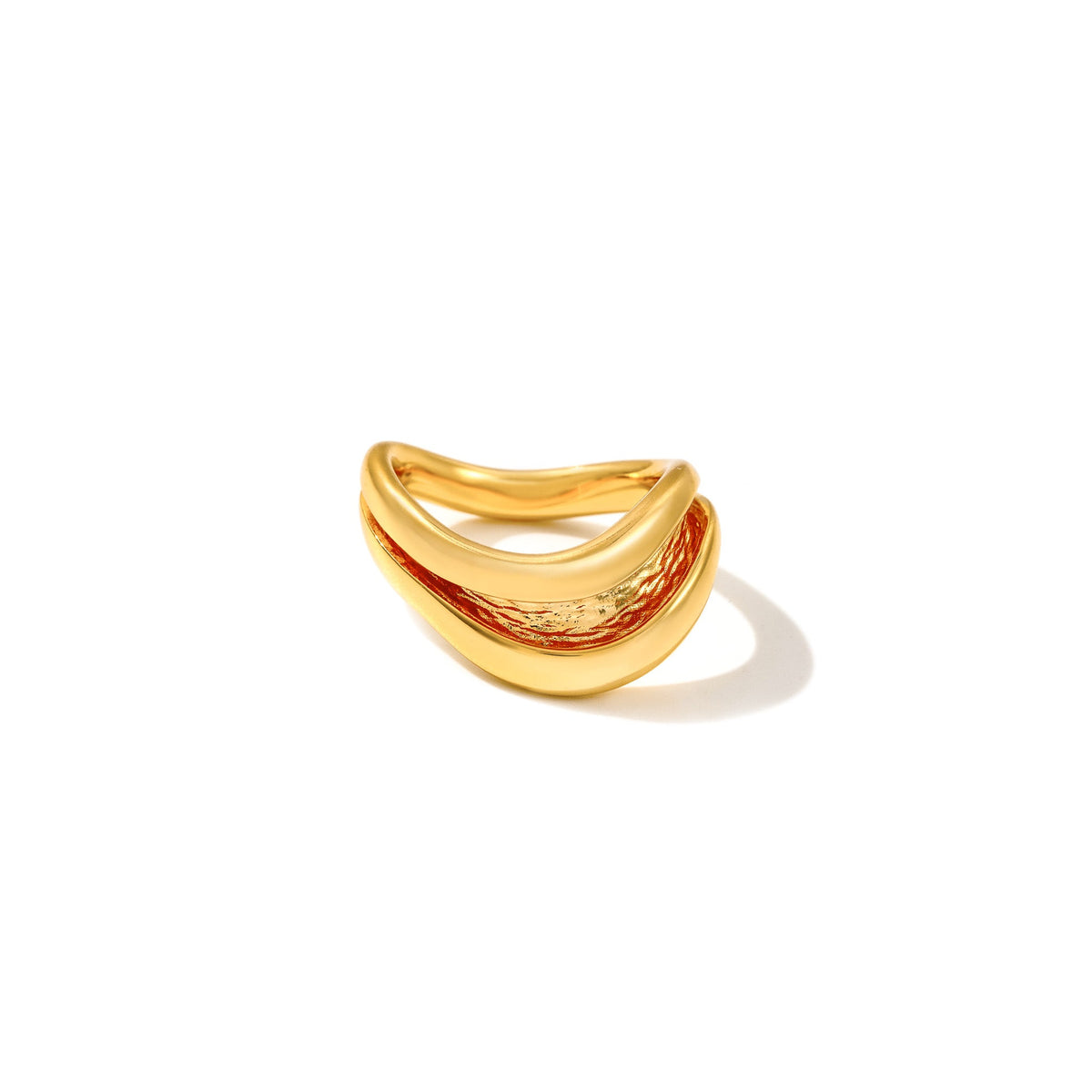 Gold Currents Wave ring with a smooth wave-form exterior and textured inner channel, on white