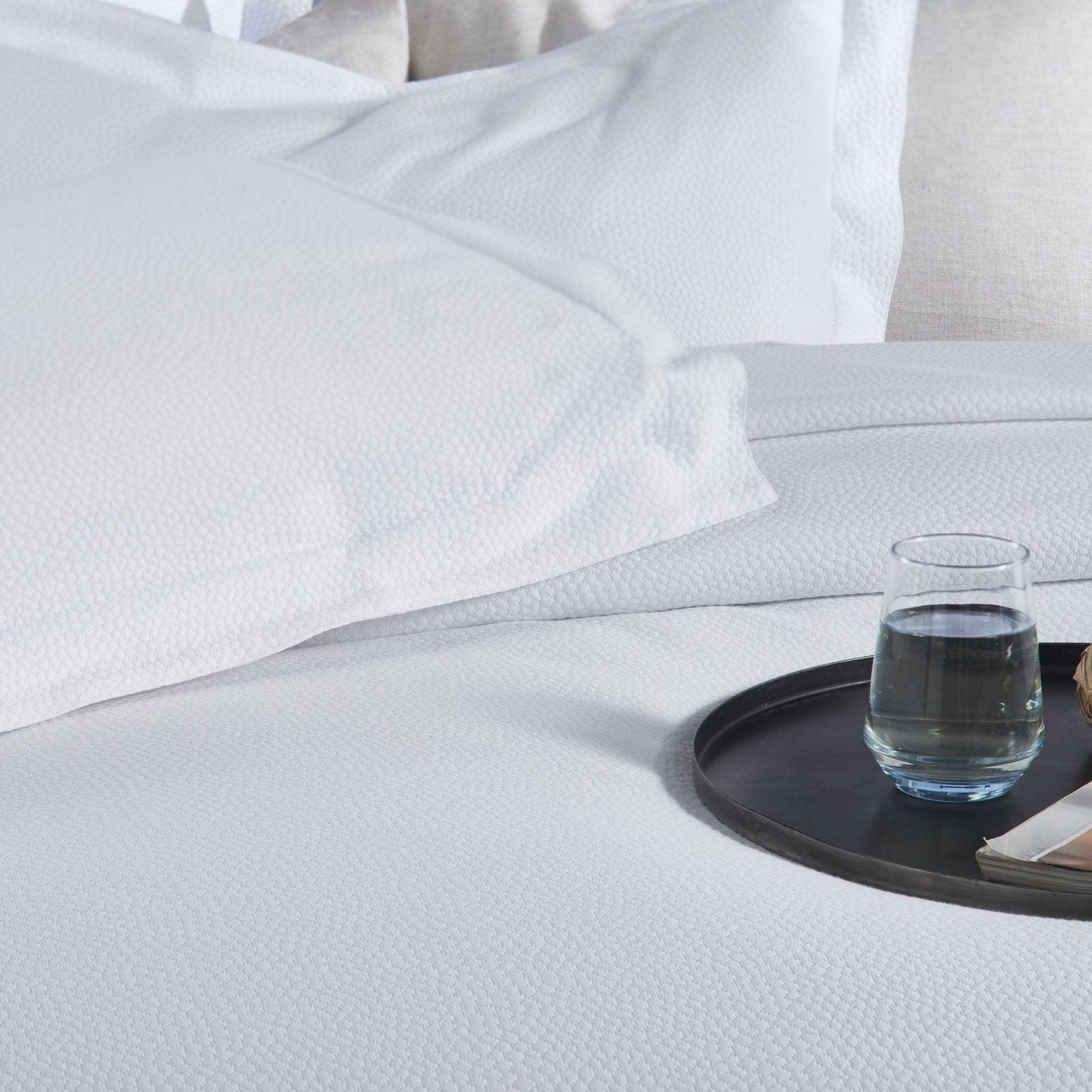 CL-258-9496_4|Crisp white coverlet featuring a delicate, subtle dimpled texture for a modern and clean bedroom design.