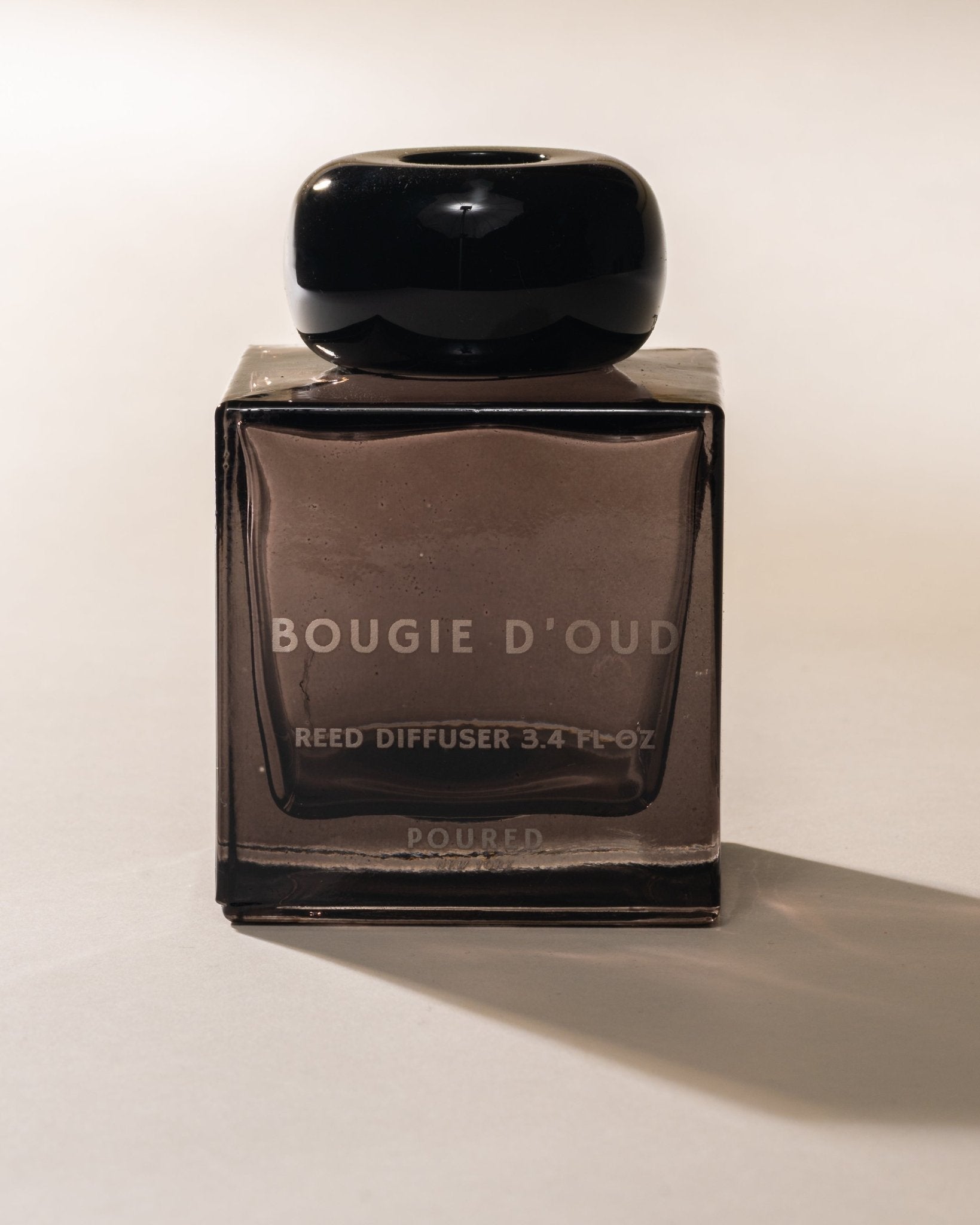 Bougie D'Oud reed diffuser with black cap on a white background