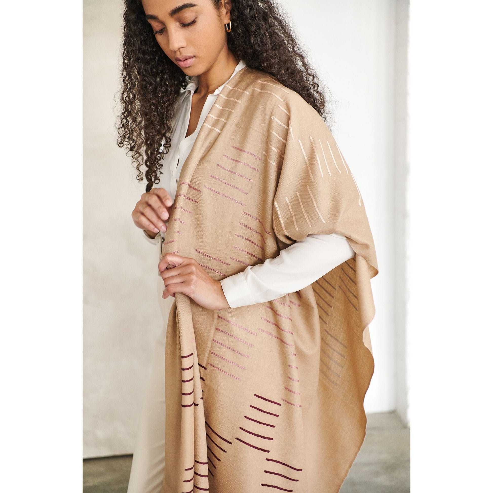 Woman wearing a Maple Beige Handwoven Hand Embroidered Classic Scarf with unique patterns.