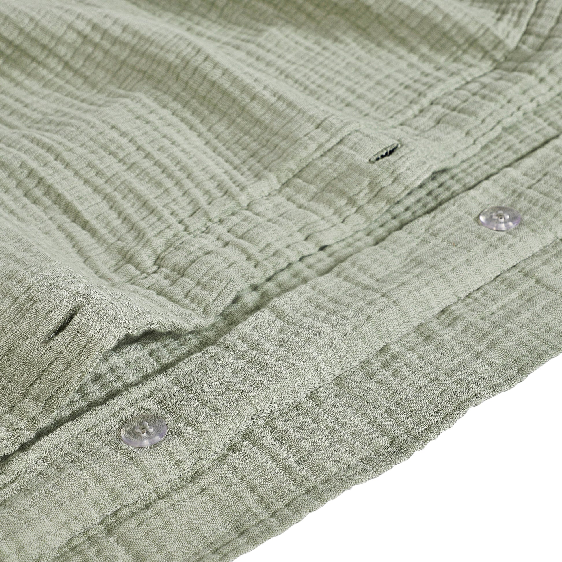 DT-051-9092_8|Close-up of the intricate crinkled texture and durable buttons of the sage green cotton duvet cover fabric.