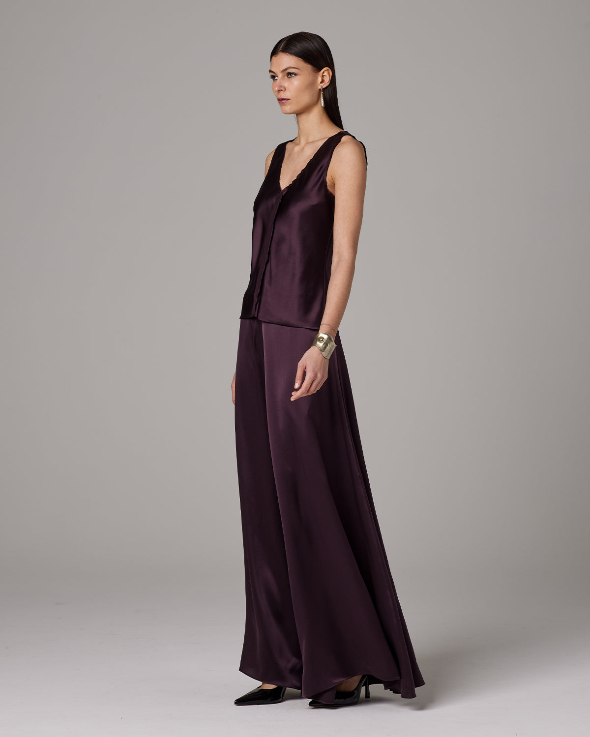 Model wearing Silk Raw Edge Tank in aubergine color