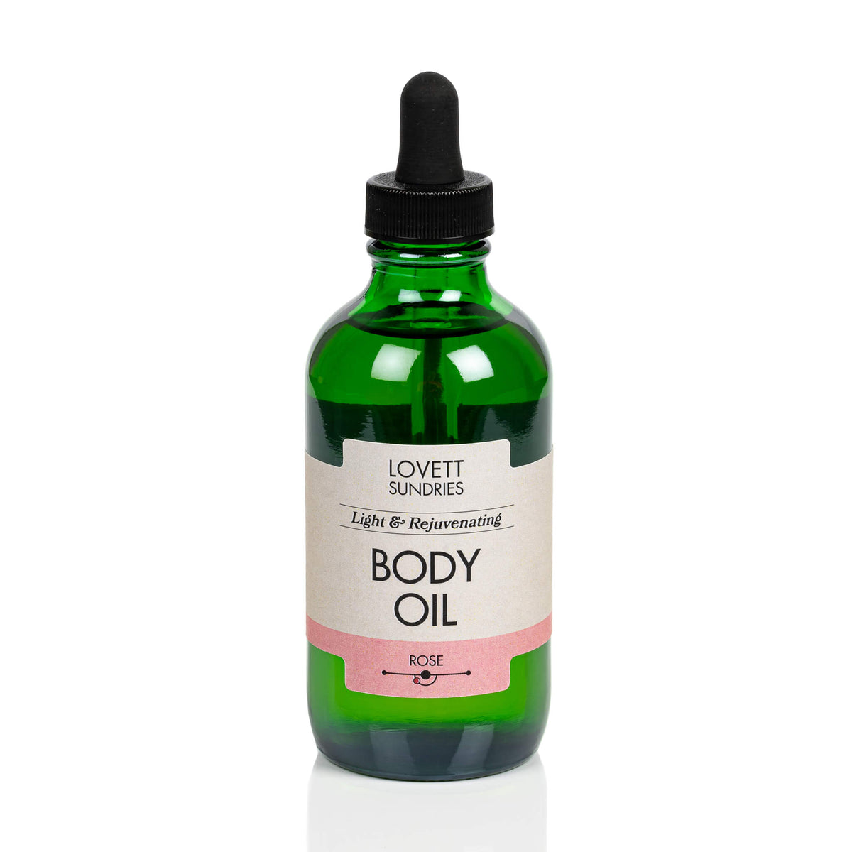 Lovett Sundries organic body oil in a green bottle with dropper.