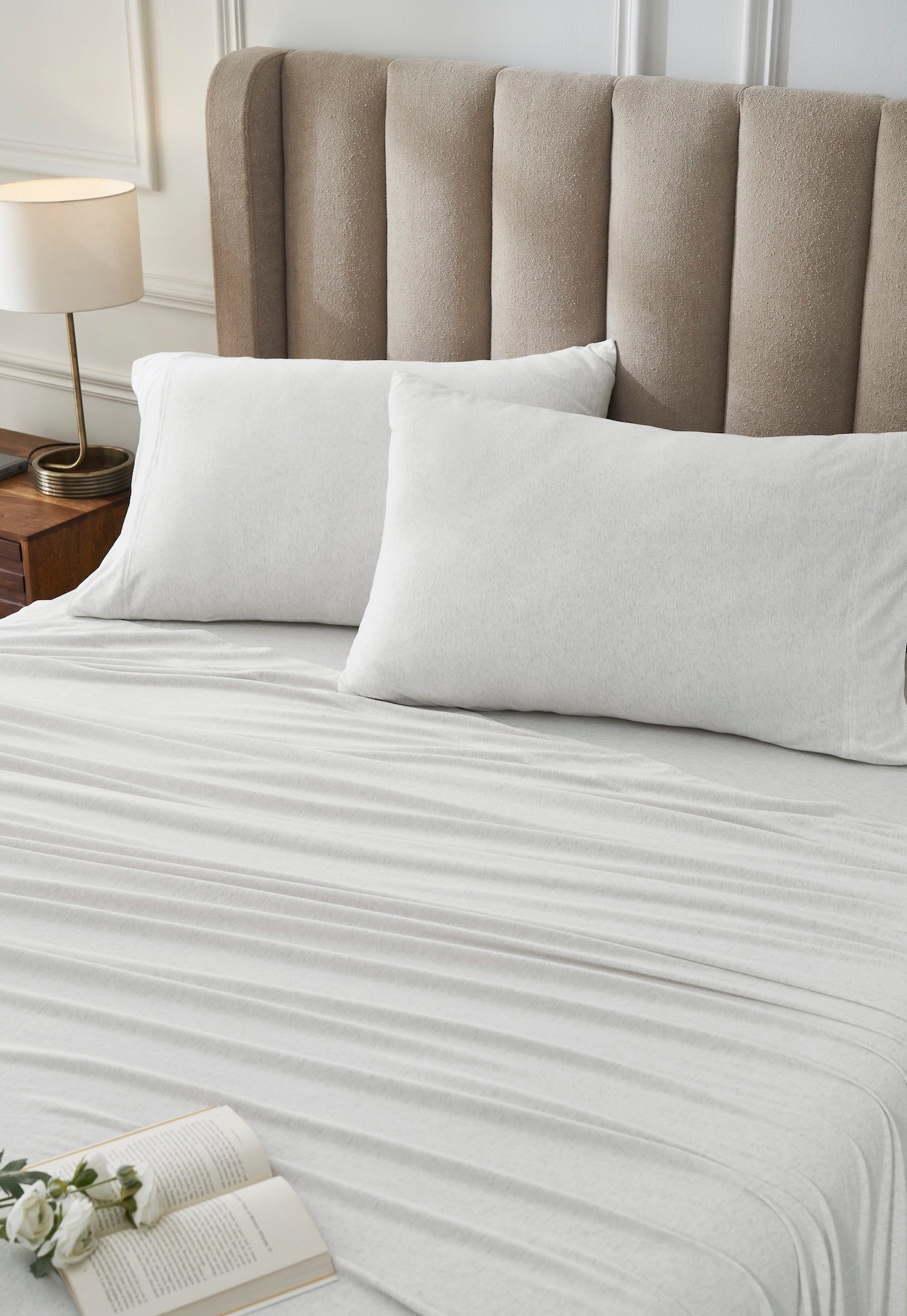 QSS-525-6080_2|Close-up of crisp white 100% cotton jersey sheets and pillowcases on a bed, enhancing sleep comfort.