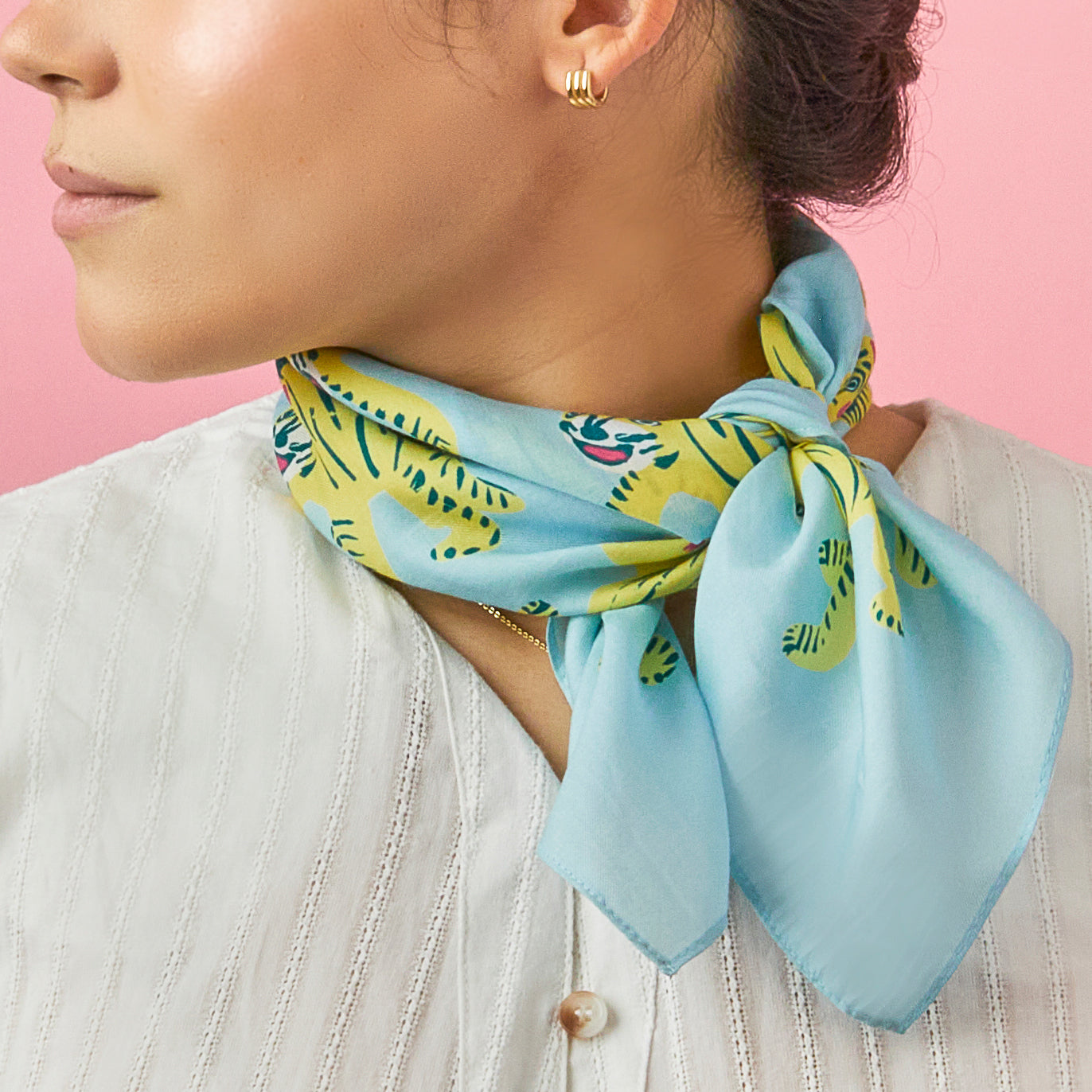 Nodding tigers cotton silk bandana on blue , pink and neon yellow for a fun look. Made of a luxurious cotton-silk blend with a precise machine-stitched hemming, perfect as head wraps or neckerchiefs, bandana hairstyles, bandana headband; bandana style is in and now. Ethically sourced.