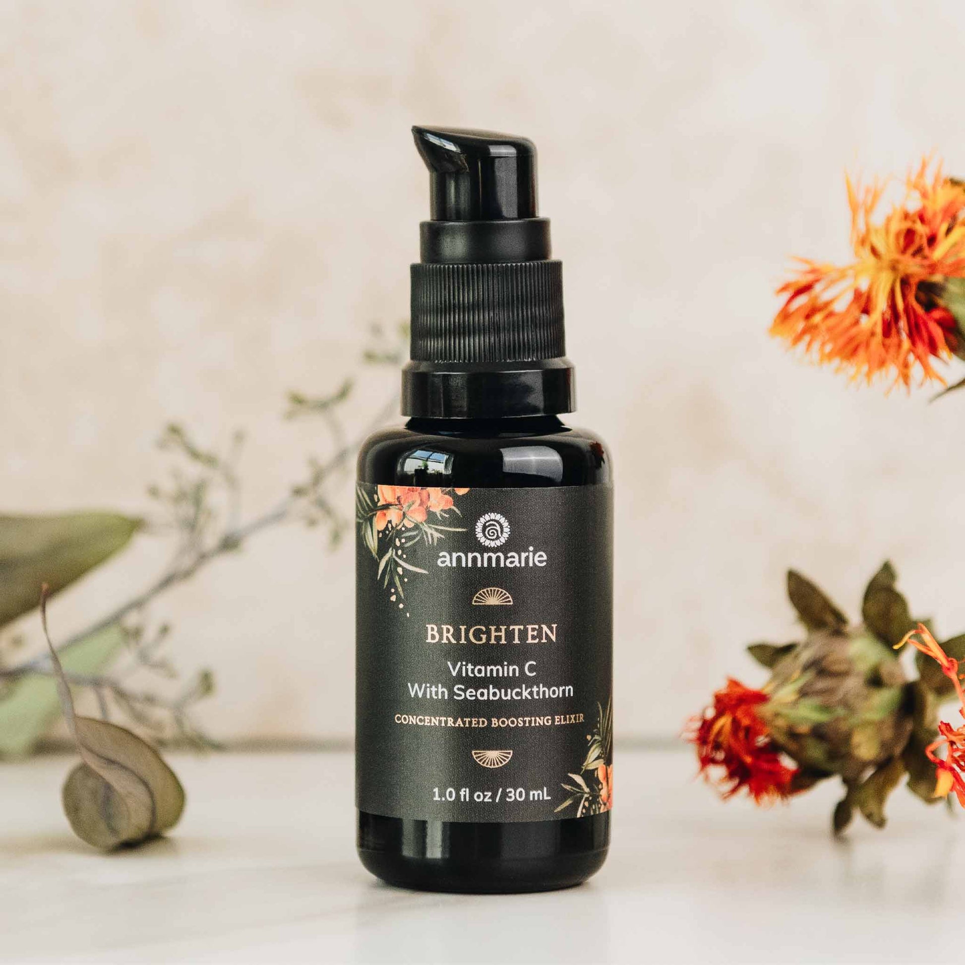 Brighten Vitamin C with Seabuckthorn concentrated boosting elixir bottle displayed with botanical elements.