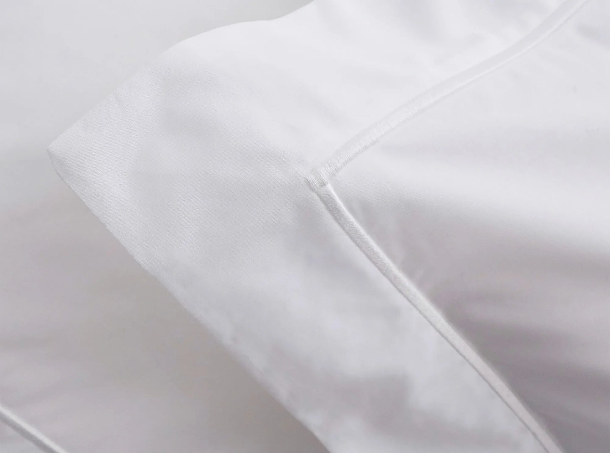 Embroidered edge detail on organic percale duvet cover in white - handcrafted in Portugal