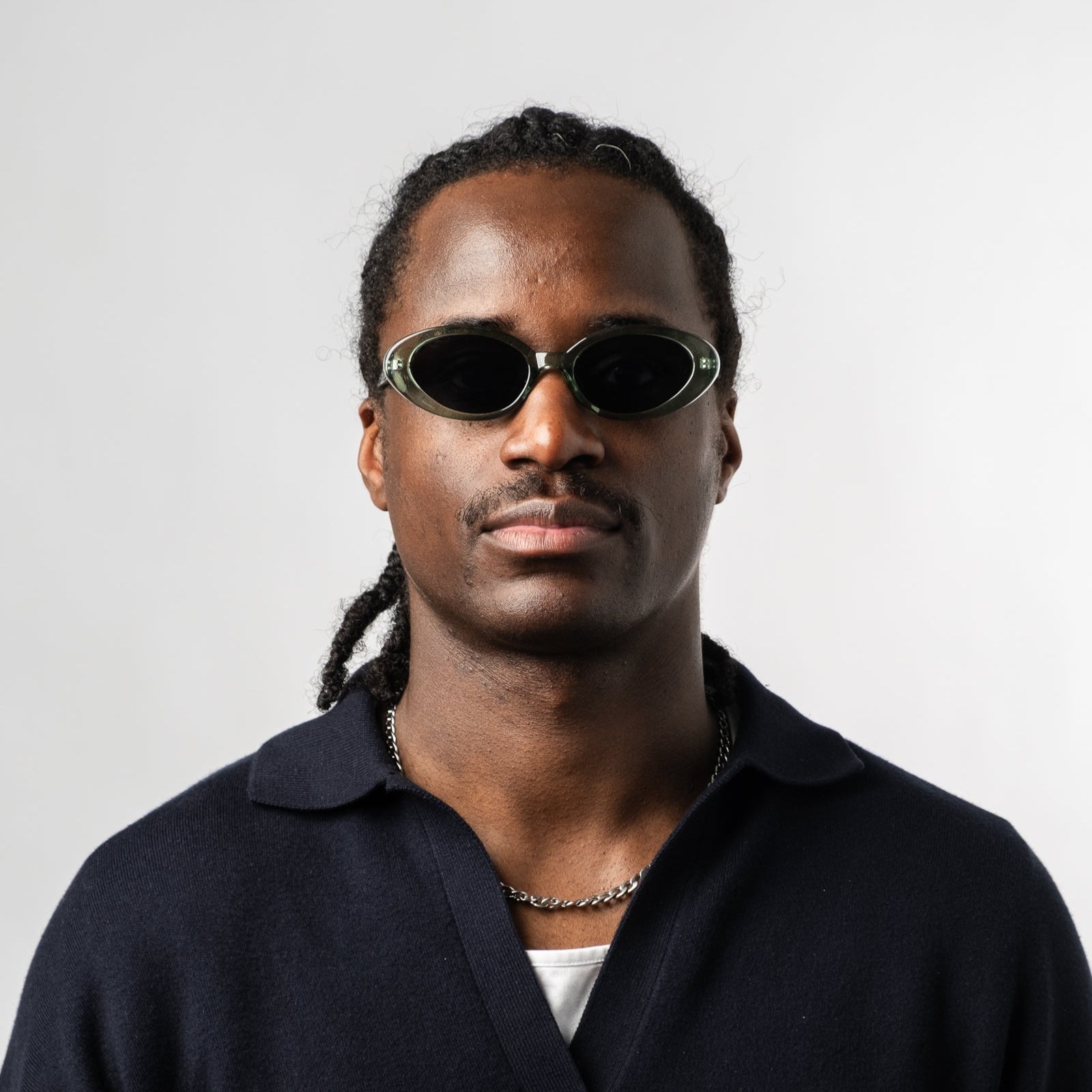 Male wearing Sad Eyewear Bloom oval sunglasses in sea glass green with tinted black lenses