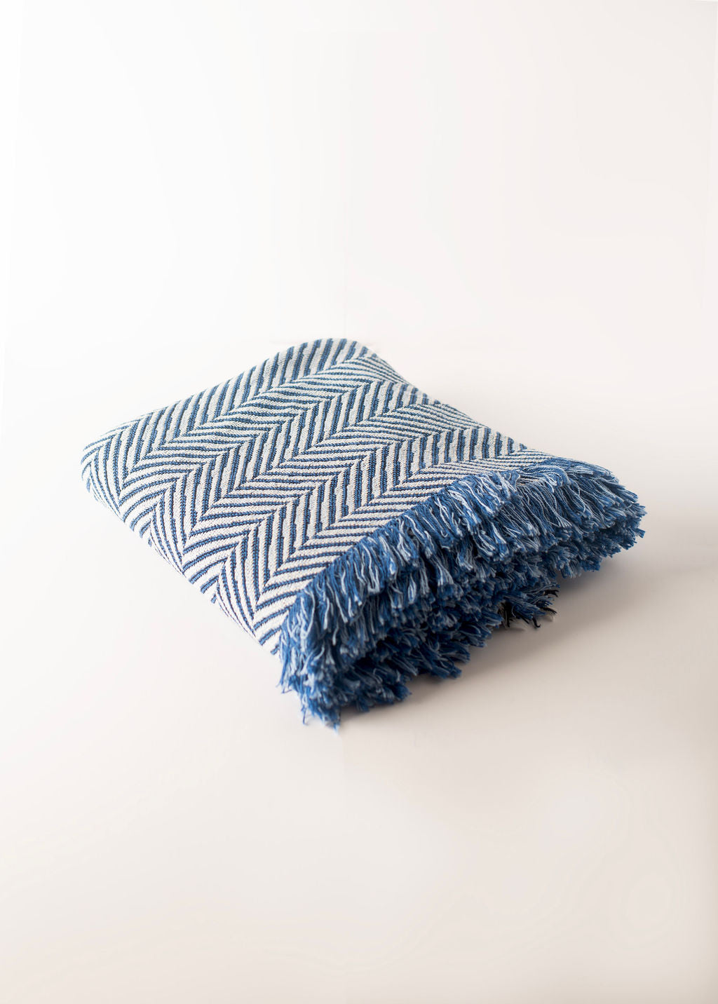 Folded Henry Chambray blue herringbone reversible jacquard woven throw blanket