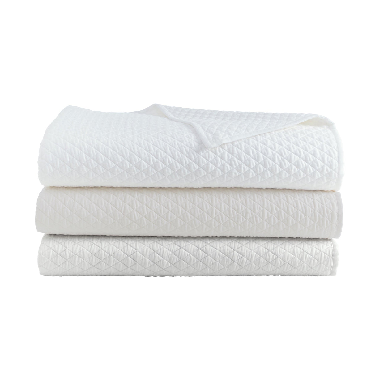 CL-265-9496_7|Stack of three diamond quilted coverlets: crisp white, soft ivory, and light gray. Luxurious bedding for a serene bedroom.