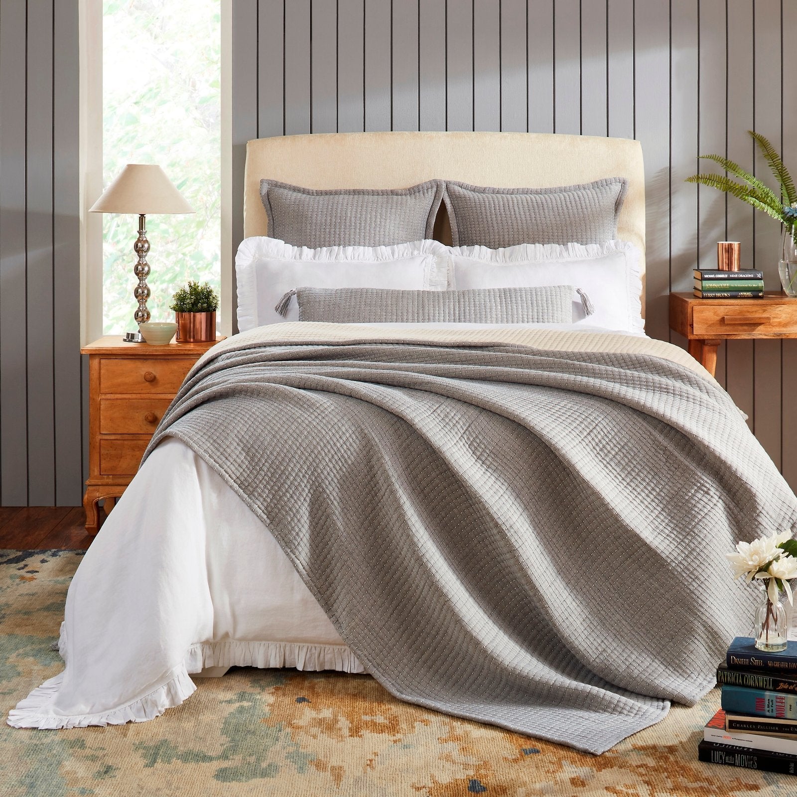 BT-108-11096_1|Stylish grey textured reversible quilt blanket elegantly draped over a bed with white sheets, enhancing modern bedroom decor.