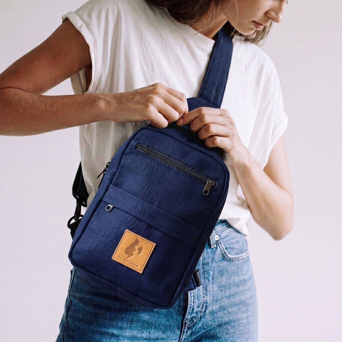 Umoja navy blue canvas sling bag flat lay #color_navy-blue