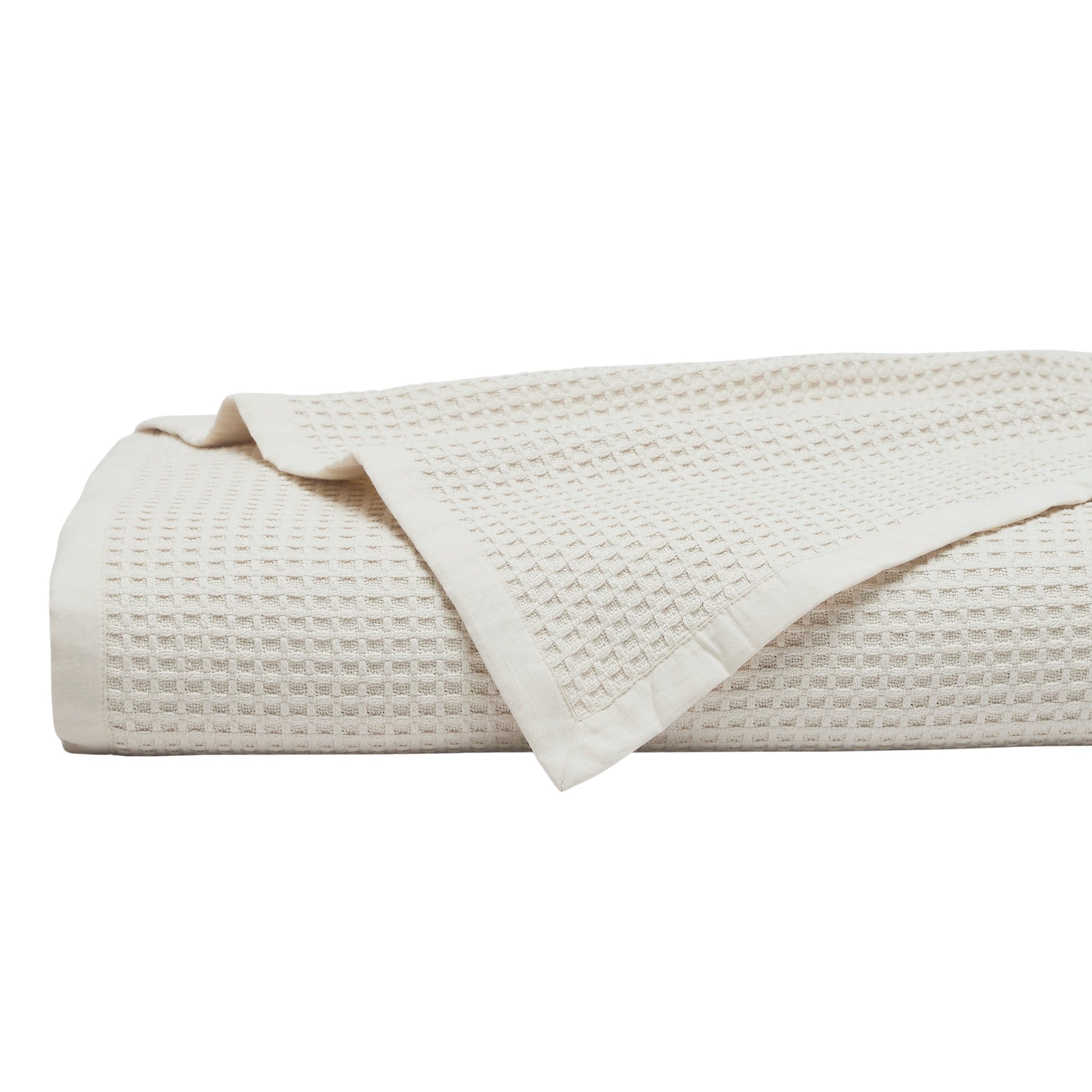 BL-867-9496_1|Folded cream waffle weave blanket. Soft, breathable cotton throw blanket for bed or sofa, adding texture and warmth to any room.