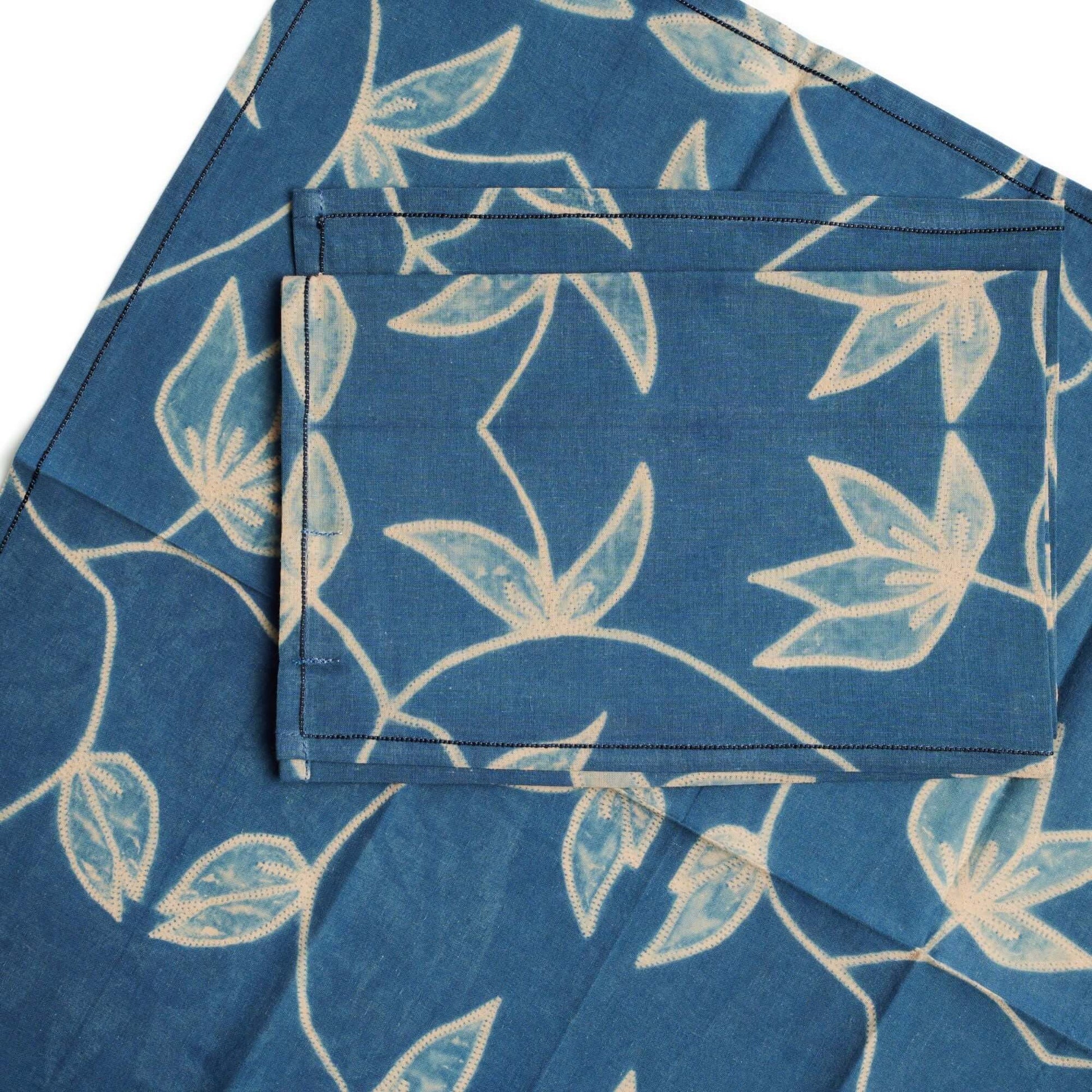 Folio Indigo Handcrafted Shibori Cotton Table Napkins ( set of 4 ) in a rich blue color with floral patterns.