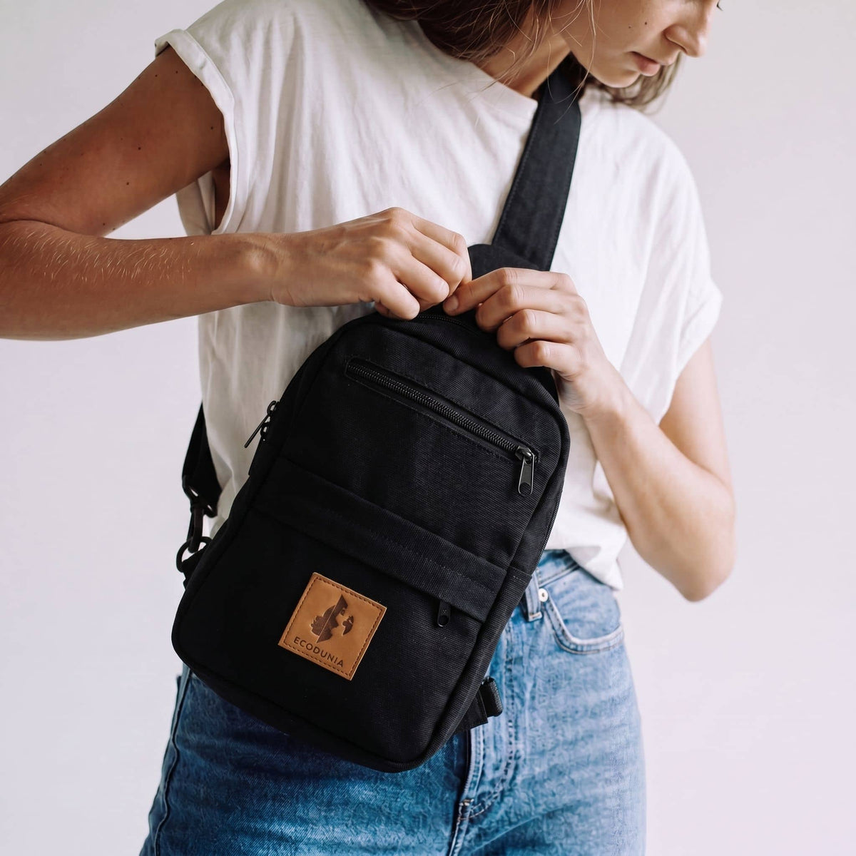 Umoja black canvas crossbody sling bag for men and women #color_black