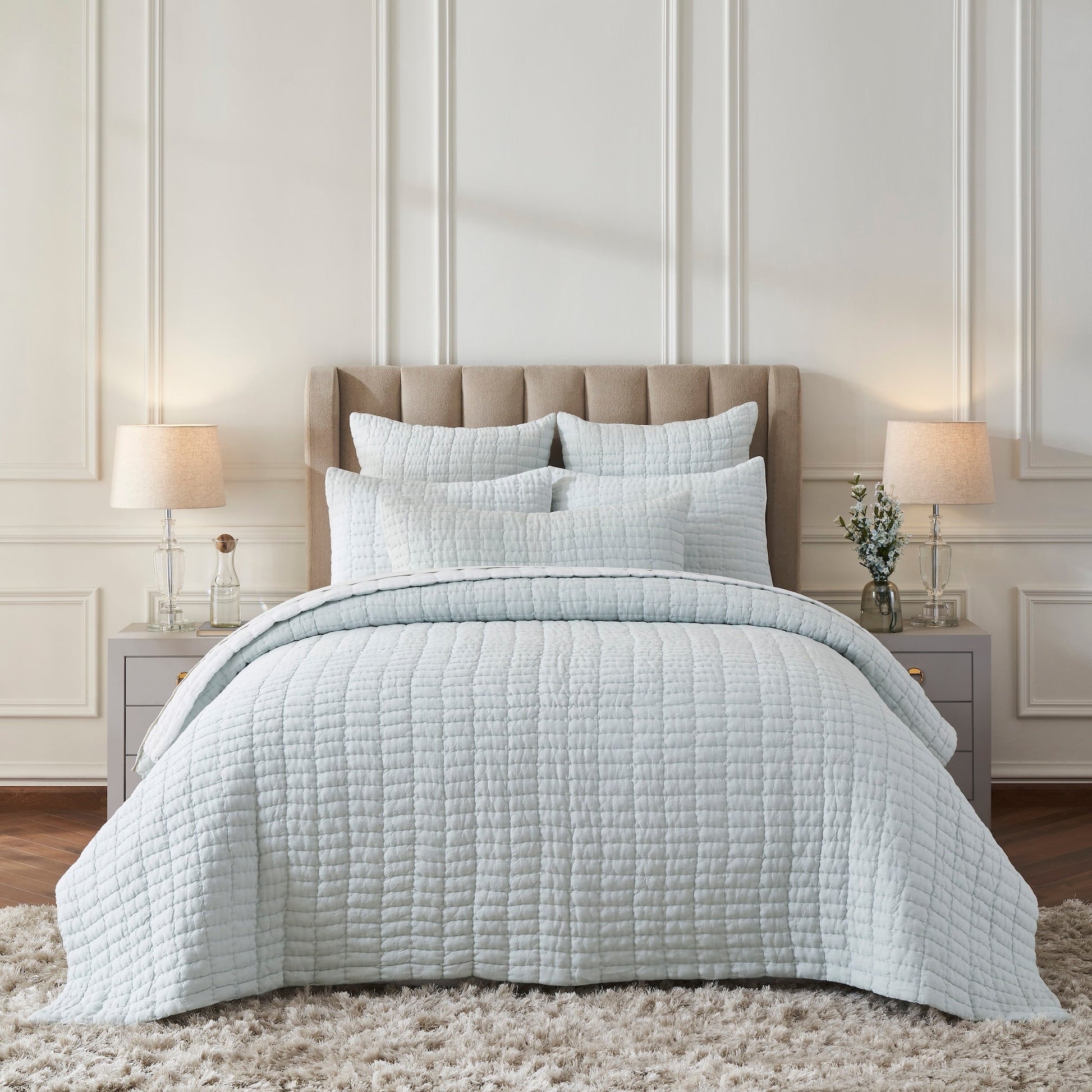 QT-373-11096_1|Elegant light blue textured quilt set adorns a serene bedroom, offering luxurious comfort and a clean, modern aesthetic.