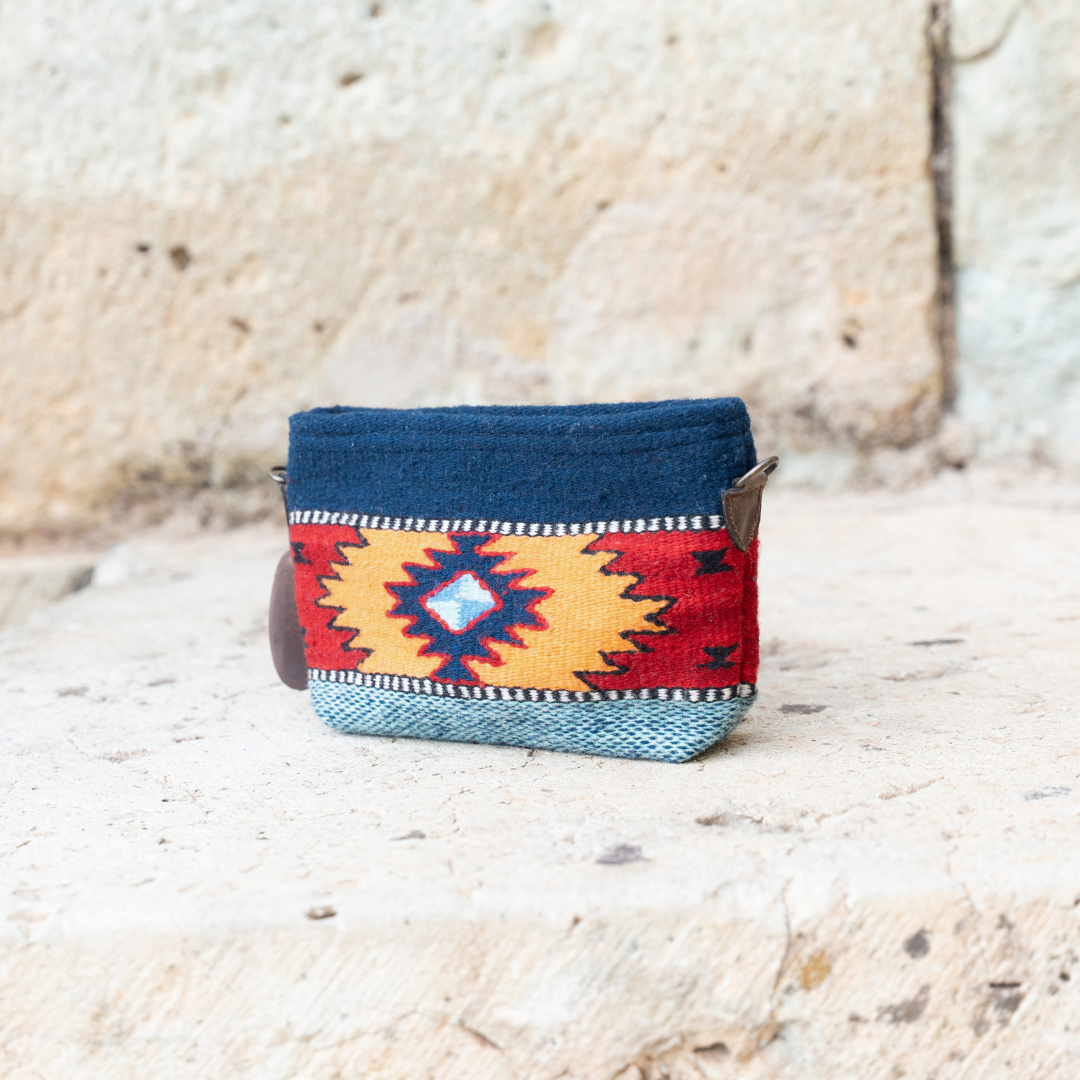 Handwoven convertible clutch with Zapotec pattern in bold colors; can be used as a pouch, wristlet, or crossbody with included leather straps and internal pocket.
