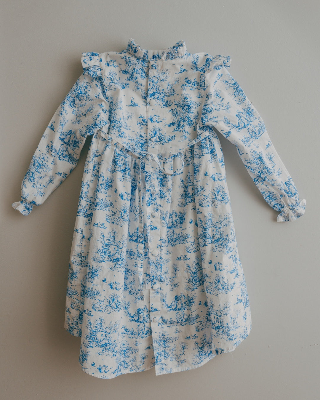 Blue Toile dress with blue floral pattern on a beige background