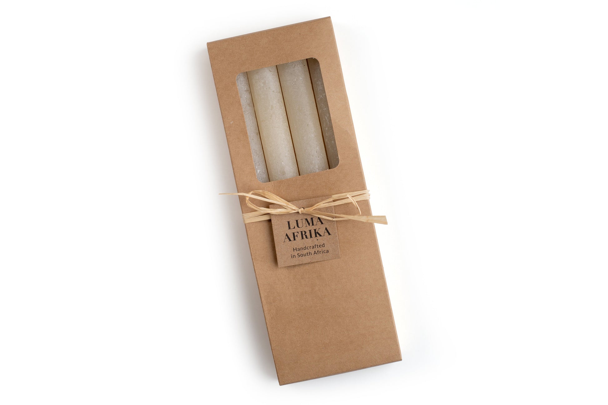 4 cream frosted tapers in a kraft bown gift box, ties with raffia and a story card. Fair Trade.
