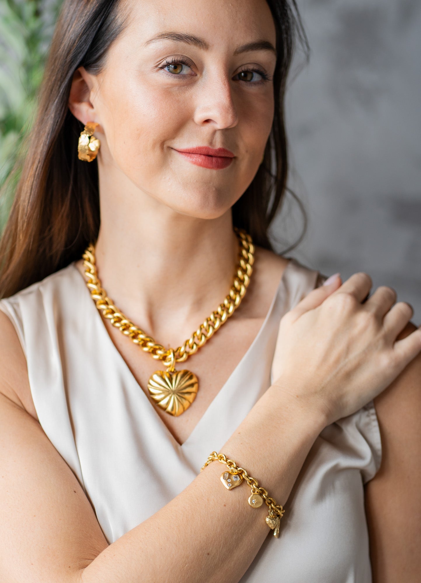 Chunky gold necklace with a large ridged heart charm and “grateful” tag, worn three ways