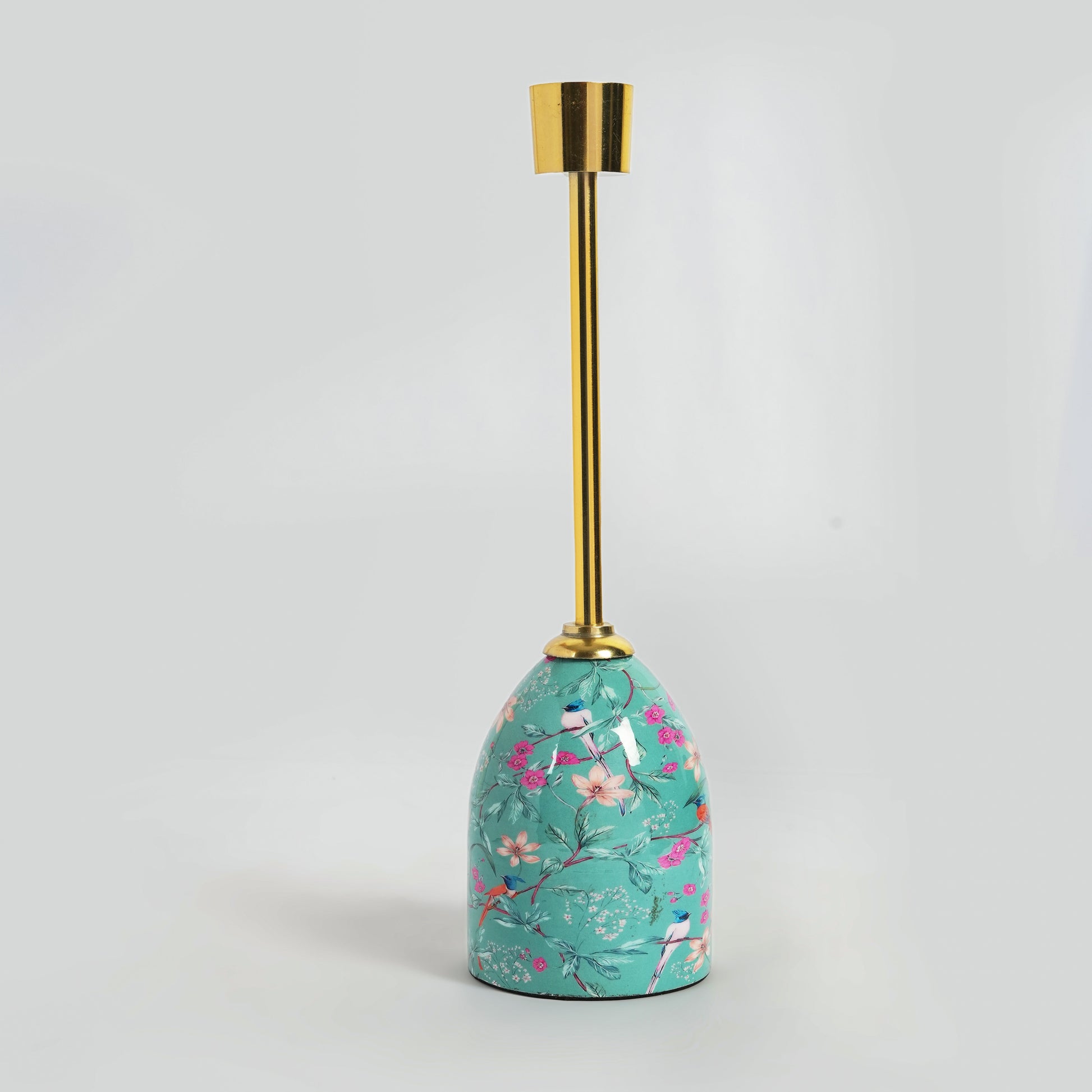 Close-up of the intricate pink and green floral motif on the glossy aqua enamel base.