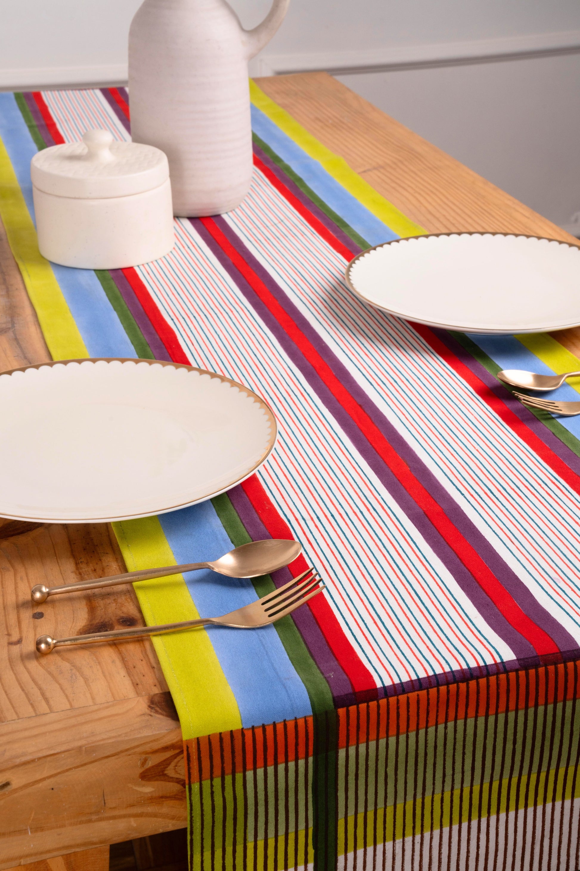 Multicolor striped table runner with dining setup