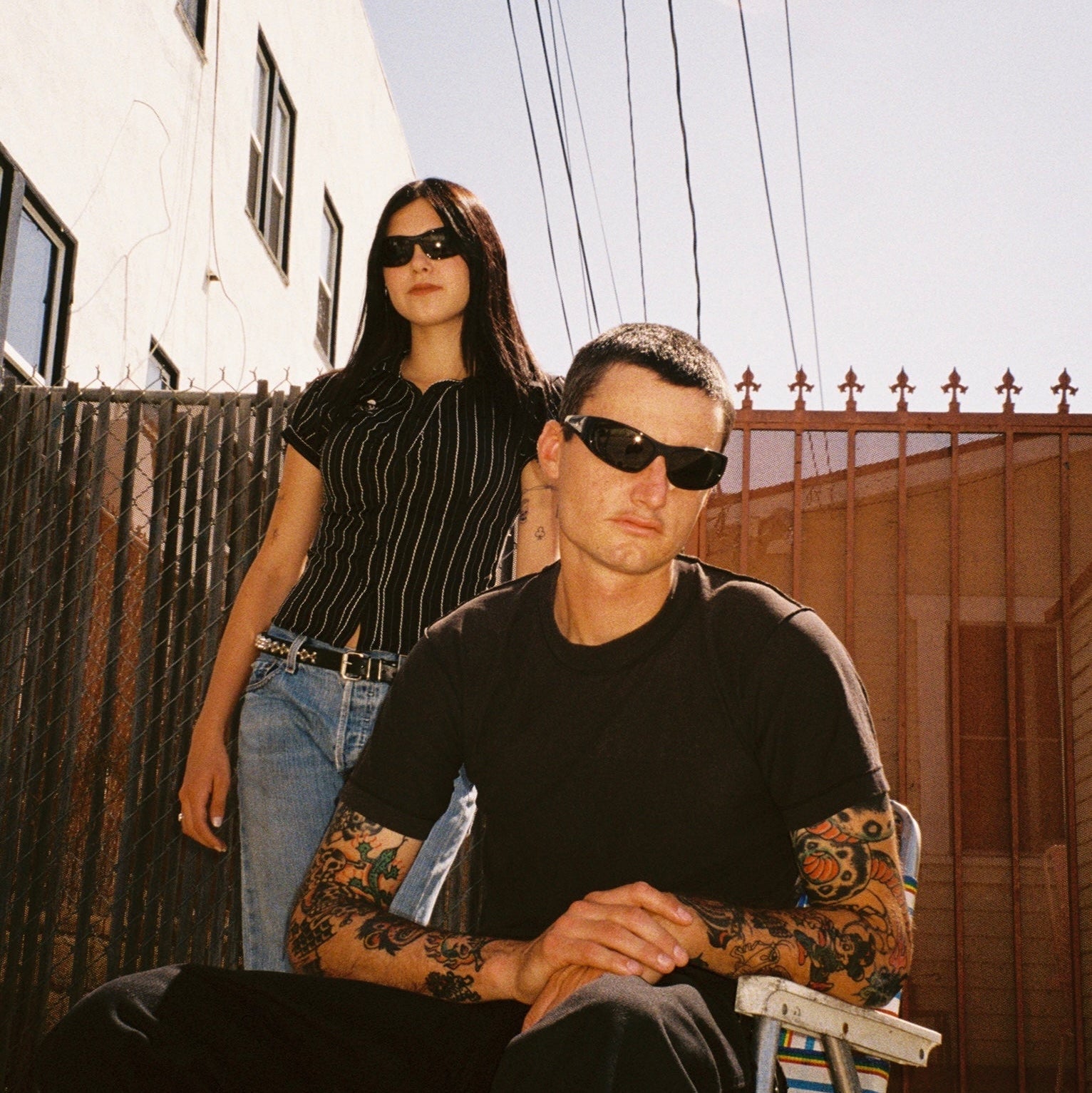 Macey Lemus and Zachary Kovacs wearing SAD Eyewear Fade wrap around sunglasses in black with polarized grey UV protection lenses