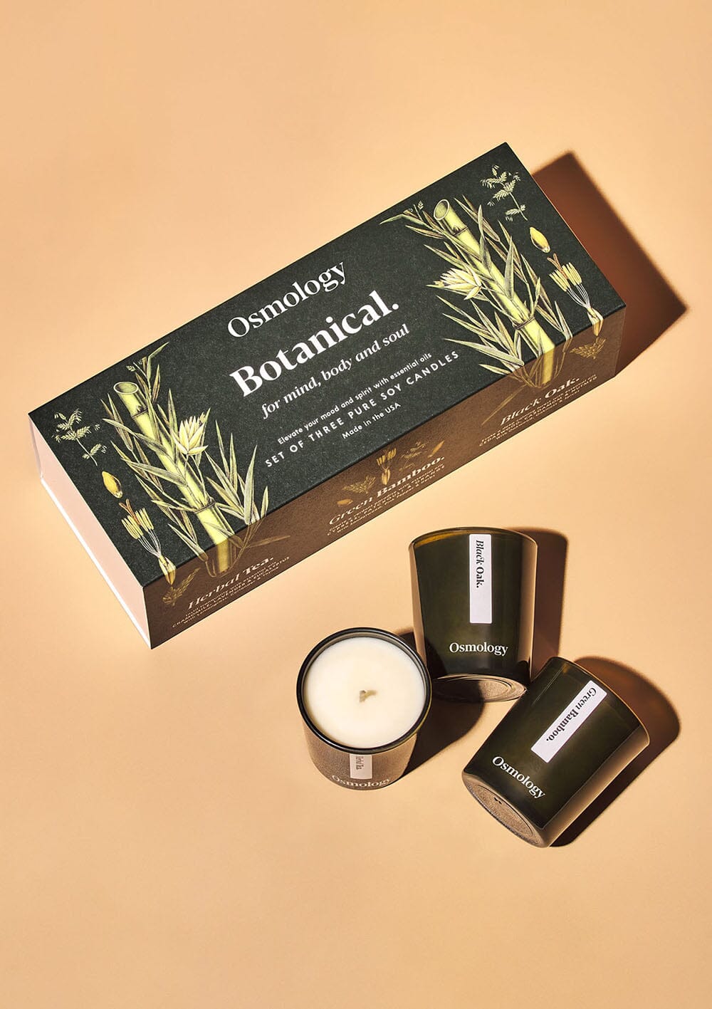 Osmology Botanical gift set, with three votive candles that include Black Oak, Green Bamboo & Herbal Tea, on white background