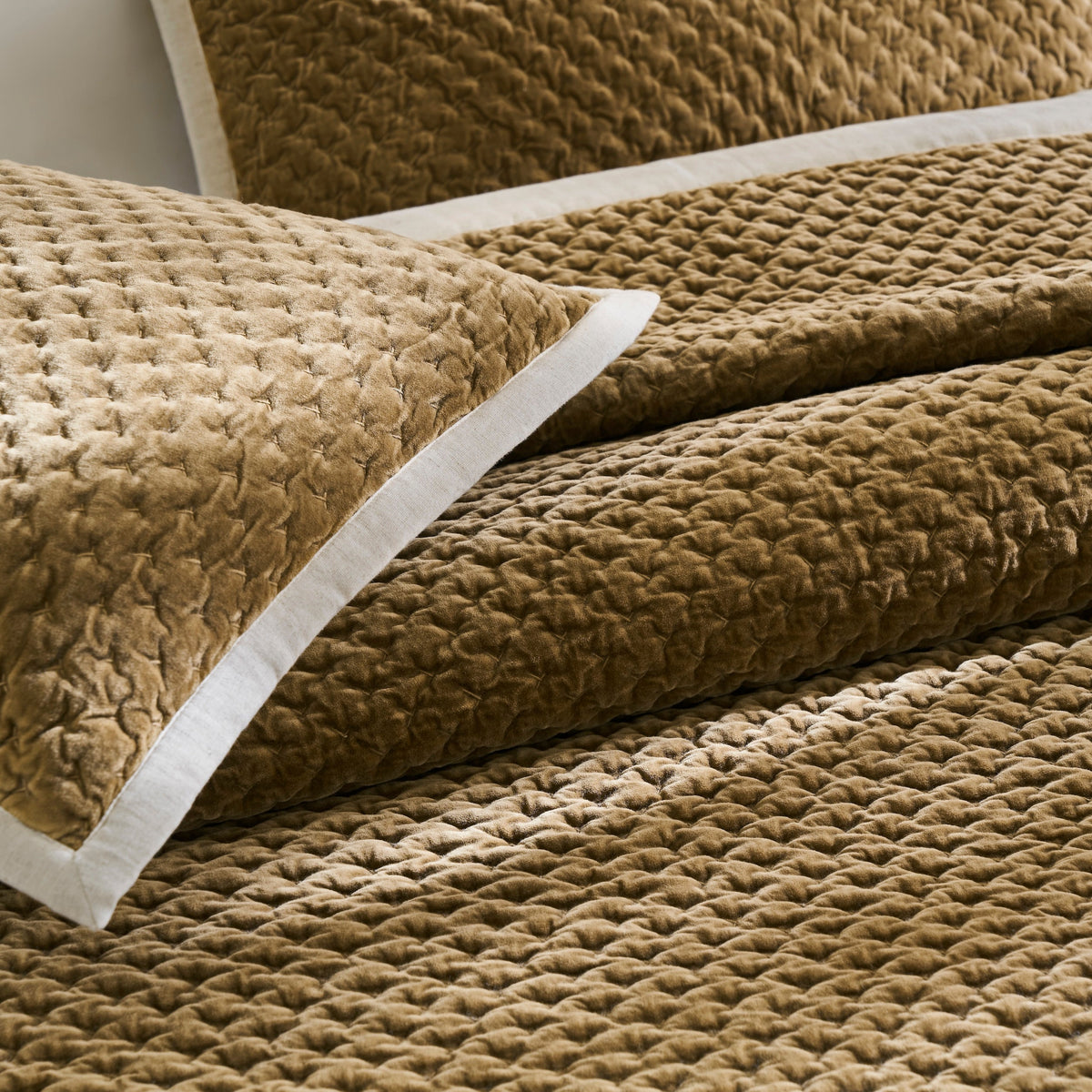 QT-378-9496_6|Close-up of golden brown quilted velvet pillow and textured bedspread, highlighting plush, soft, and luxurious bedding.
