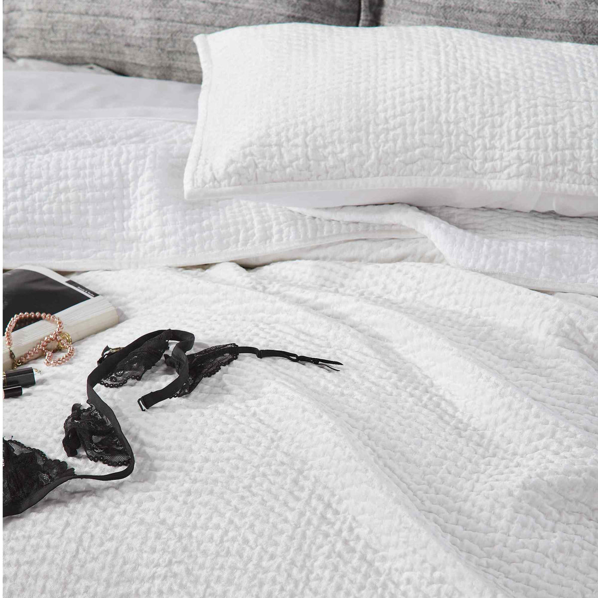 CL-182-9496_3|White textured coverlet on a queen bed, elegant quilted bedding for a serene and luxurious sleep space. (119 chars)