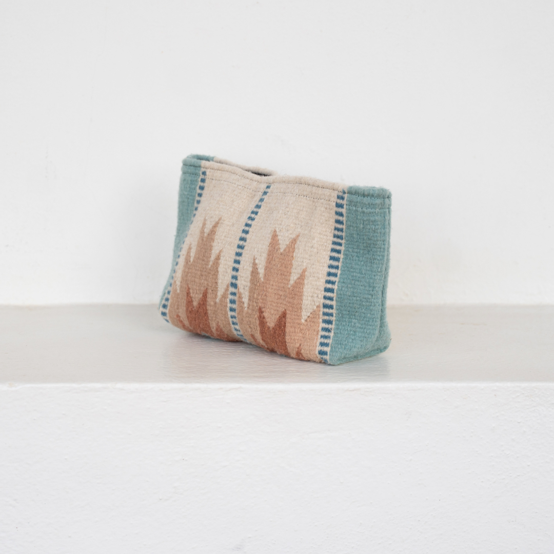 Handwoven pouch with abstract Zapotec lightning design in rose and blue tones, featuring internal pocket; ideal for use as a makeup bag, wallet, or tote organizer.
