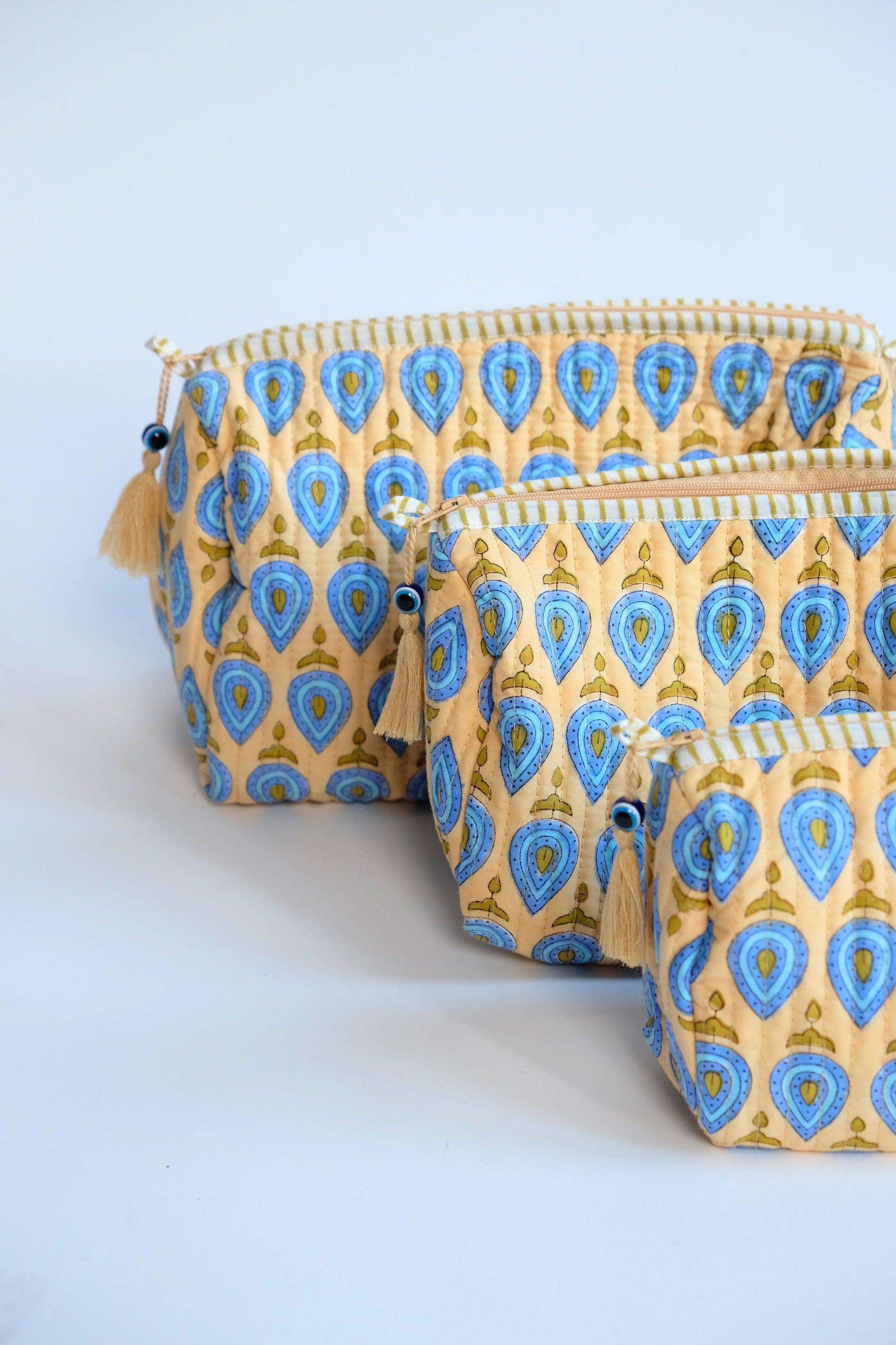 Set of beige quilted evil eye toiletry bags in multiple sizes - Inner Child