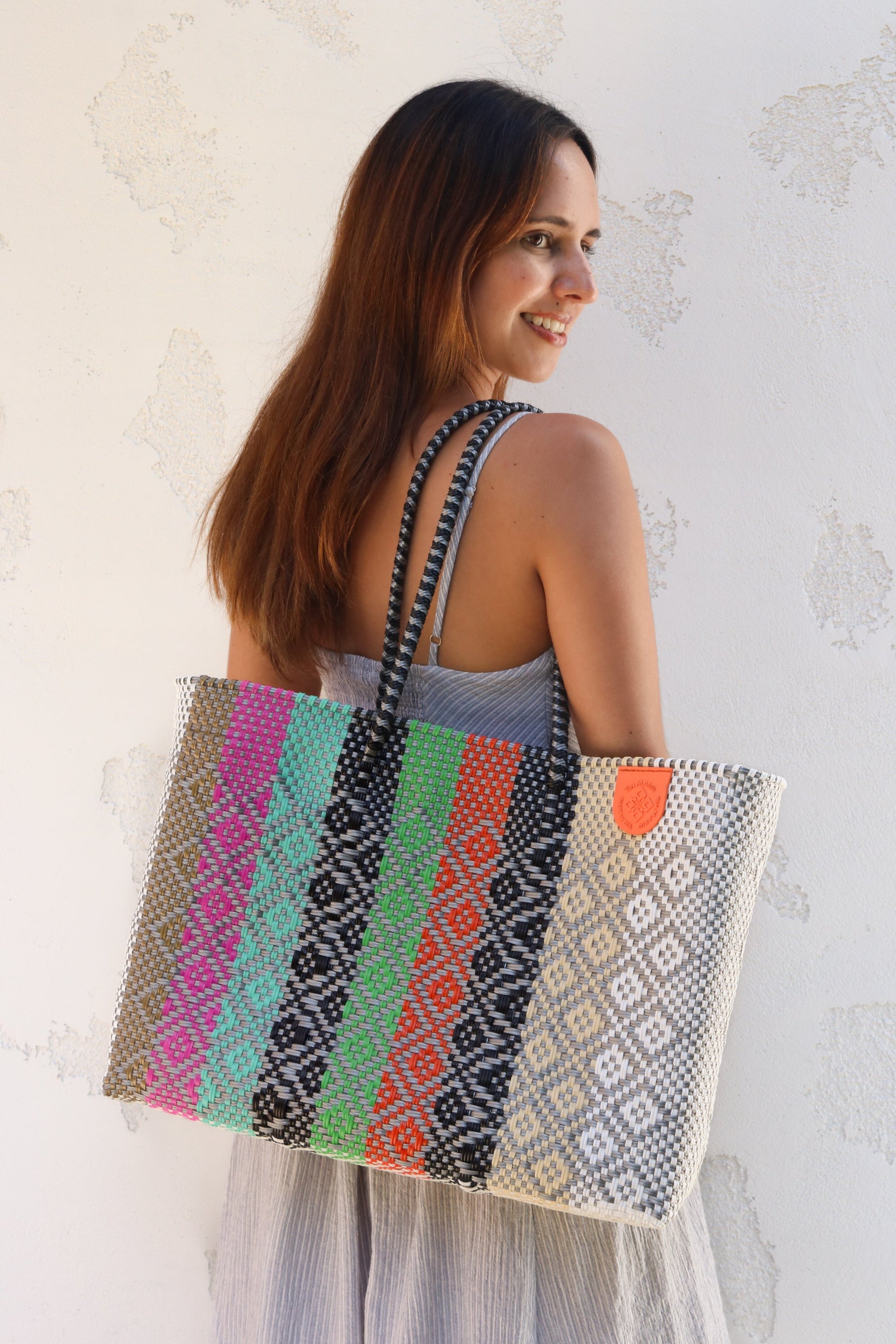 Tin Marin super tote in Maya Design, A model carrying Tin Marin woven super tote multicolored