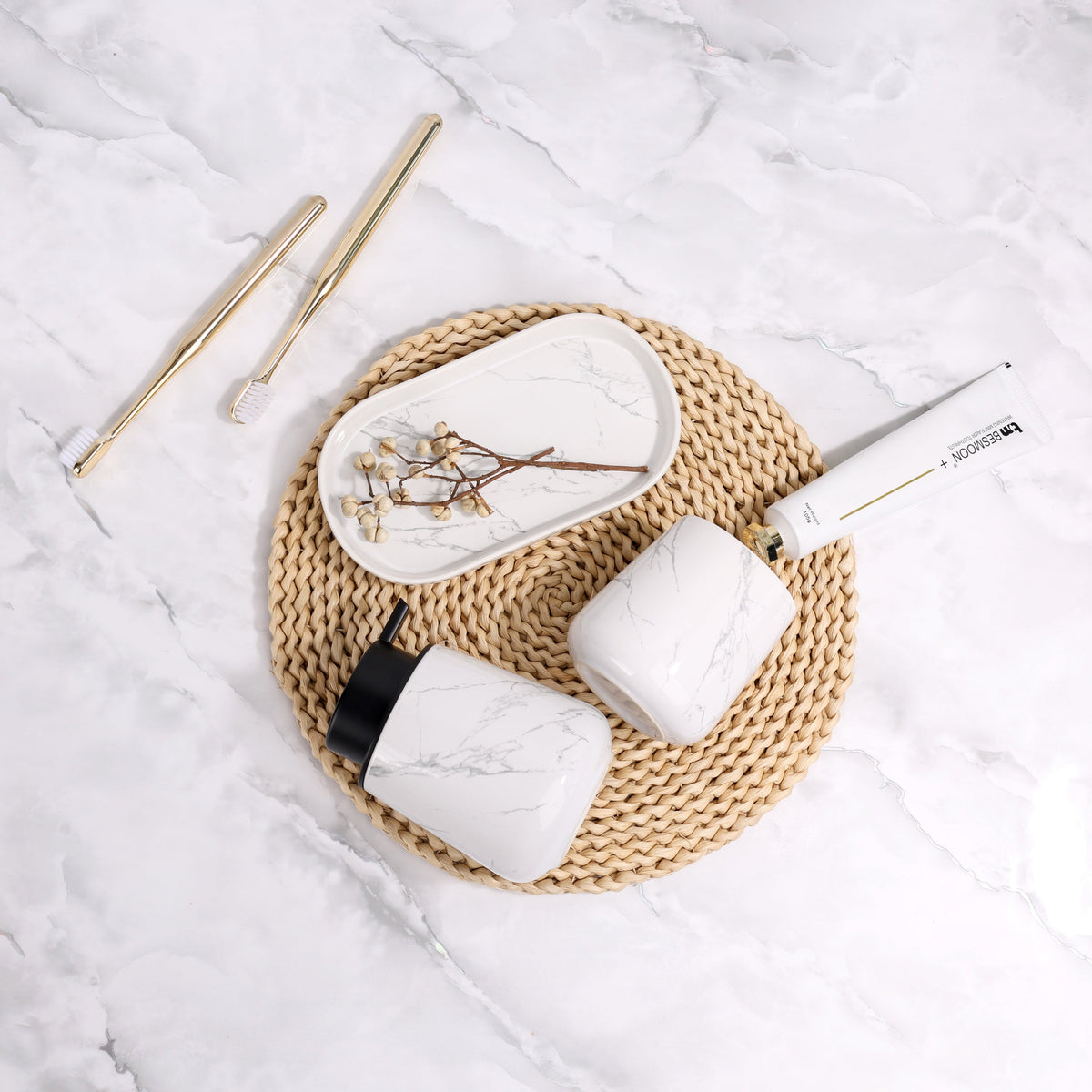 Overhead lifestyle view of the BosilunLife Marble recycled eco-clay 3-piece bathroom set elegantly arranged on a round woven mat.