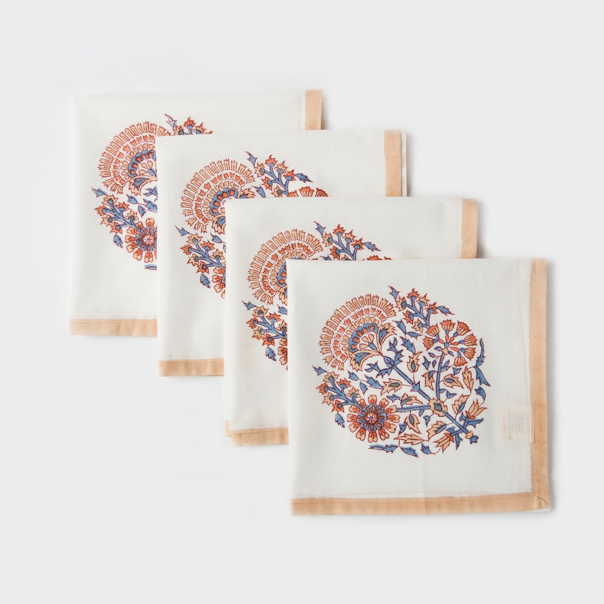 Square 18x18 inch Saffra cloth napkins featuring traditional Indian hand-carved floral motifs.