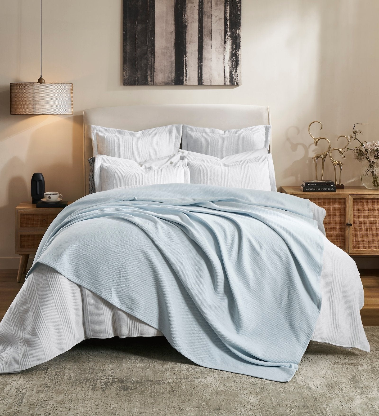 BL-859-9496_1|Light blue waffle weave blanket draped casually over a white bed in a modern bedroom setting. Cozy and inviting.