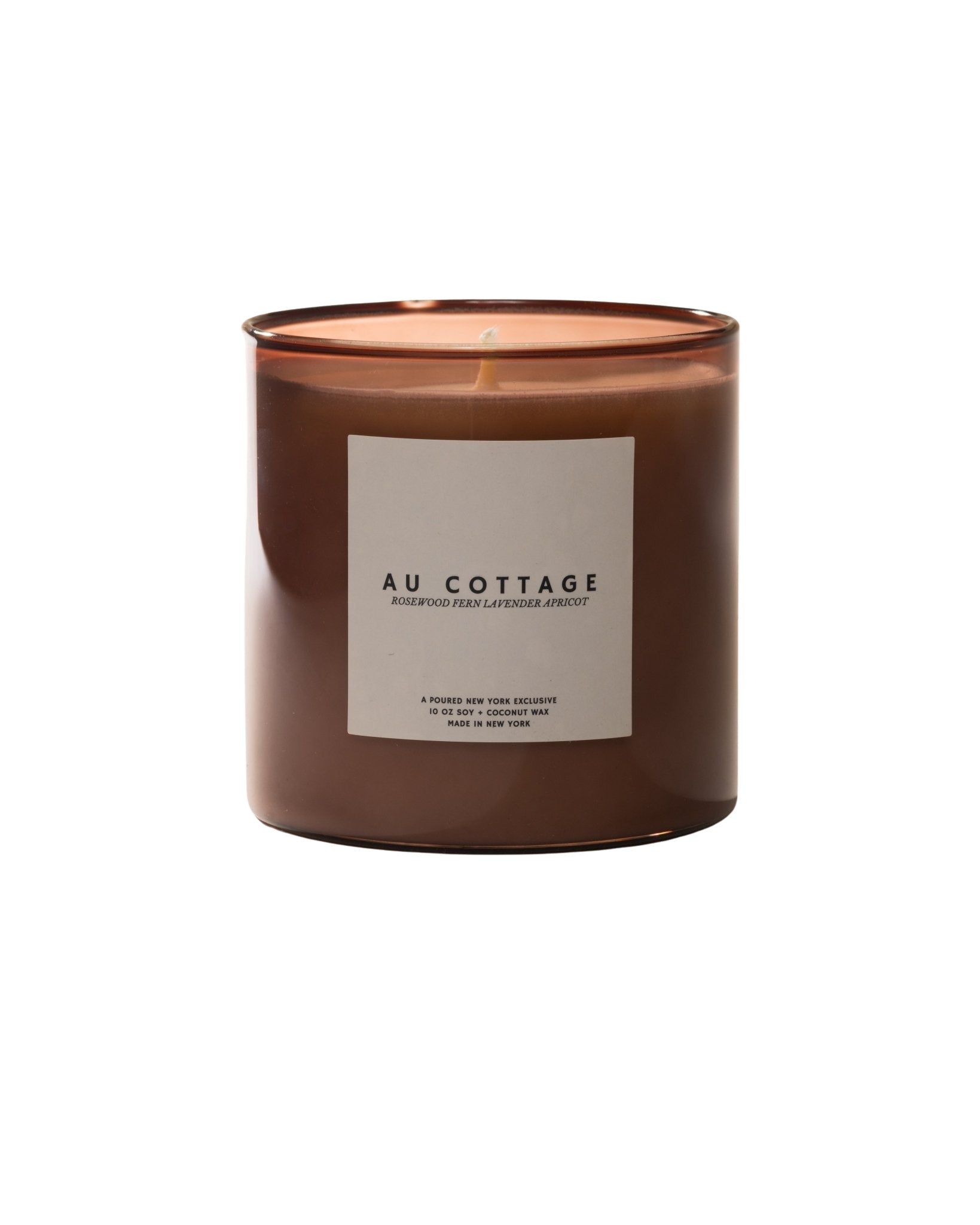 Poured New York 'Au Cottage' nude colored glass candle with grey candle box and lavender decal on a neutral background