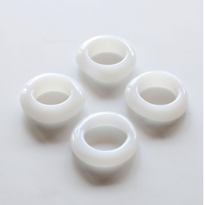 Pearl White glass napkin rings close up showing hand-cast texture detail - Goldie Home