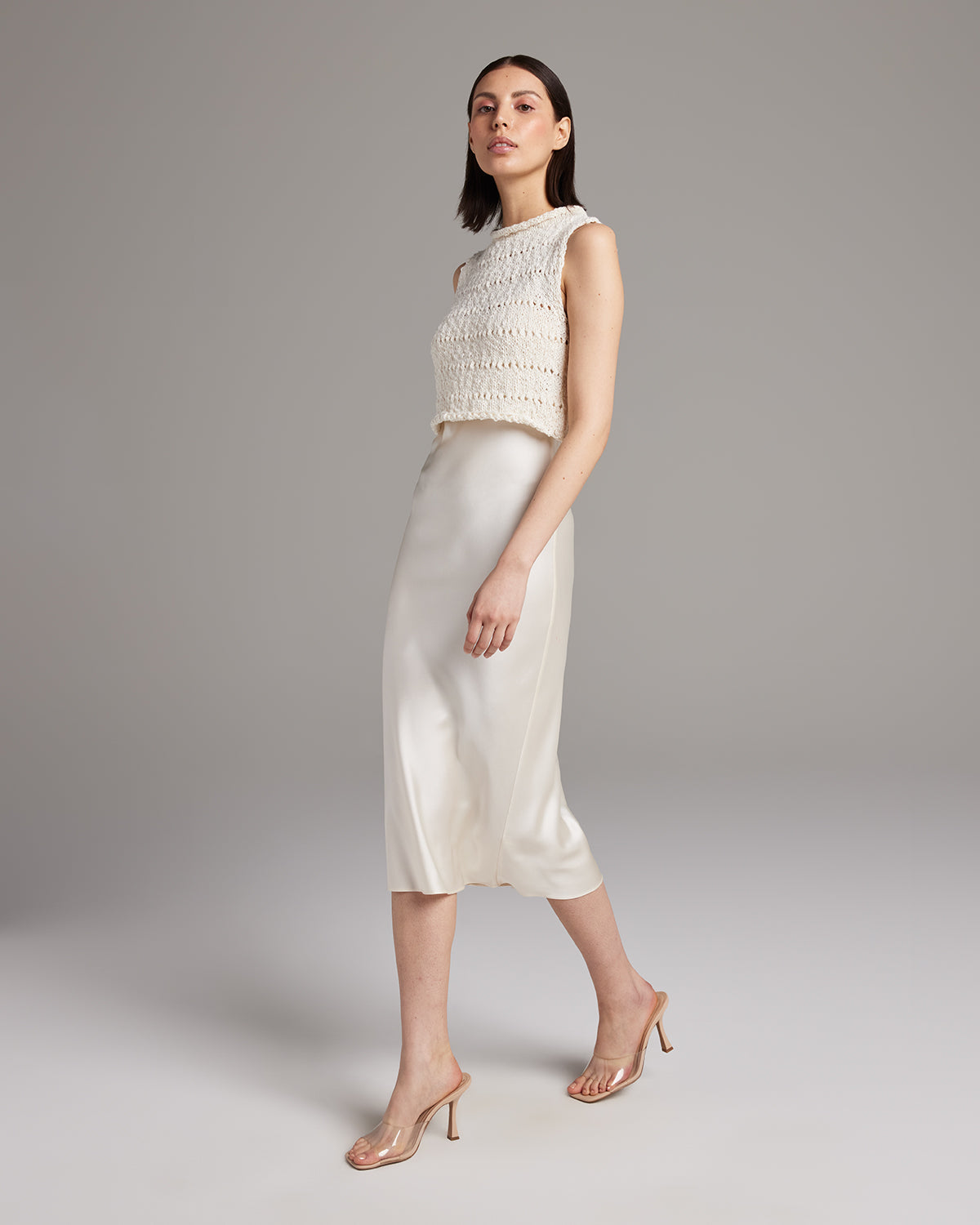 Model wearing a Flammé Knit Crop Top with a satin skirt