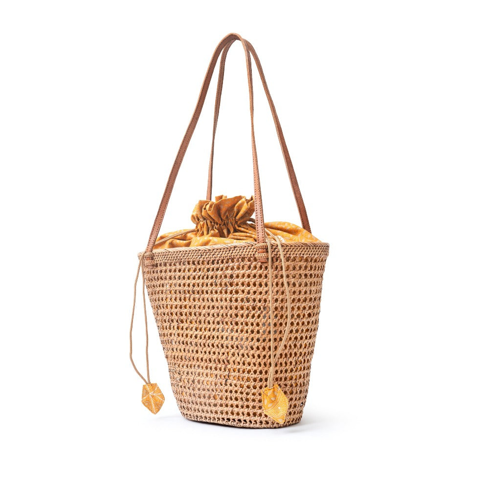 Detail view honey brown open weave mesh wicker basket shoulder tote handbag
