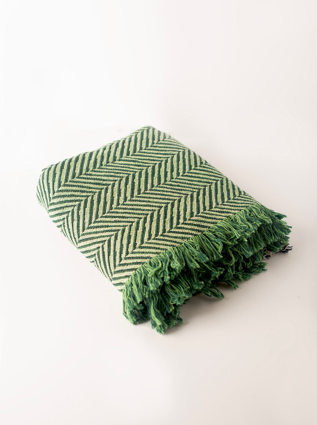 Folded Henry Verbena green herringbone reversible jacquard woven throw blanket