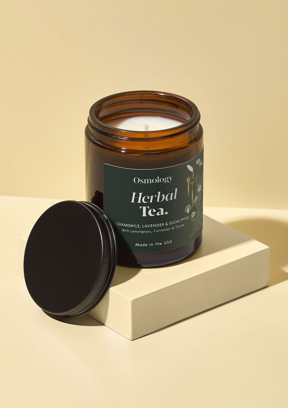 Osmology Herbal Tea jar candle with open lid on white background